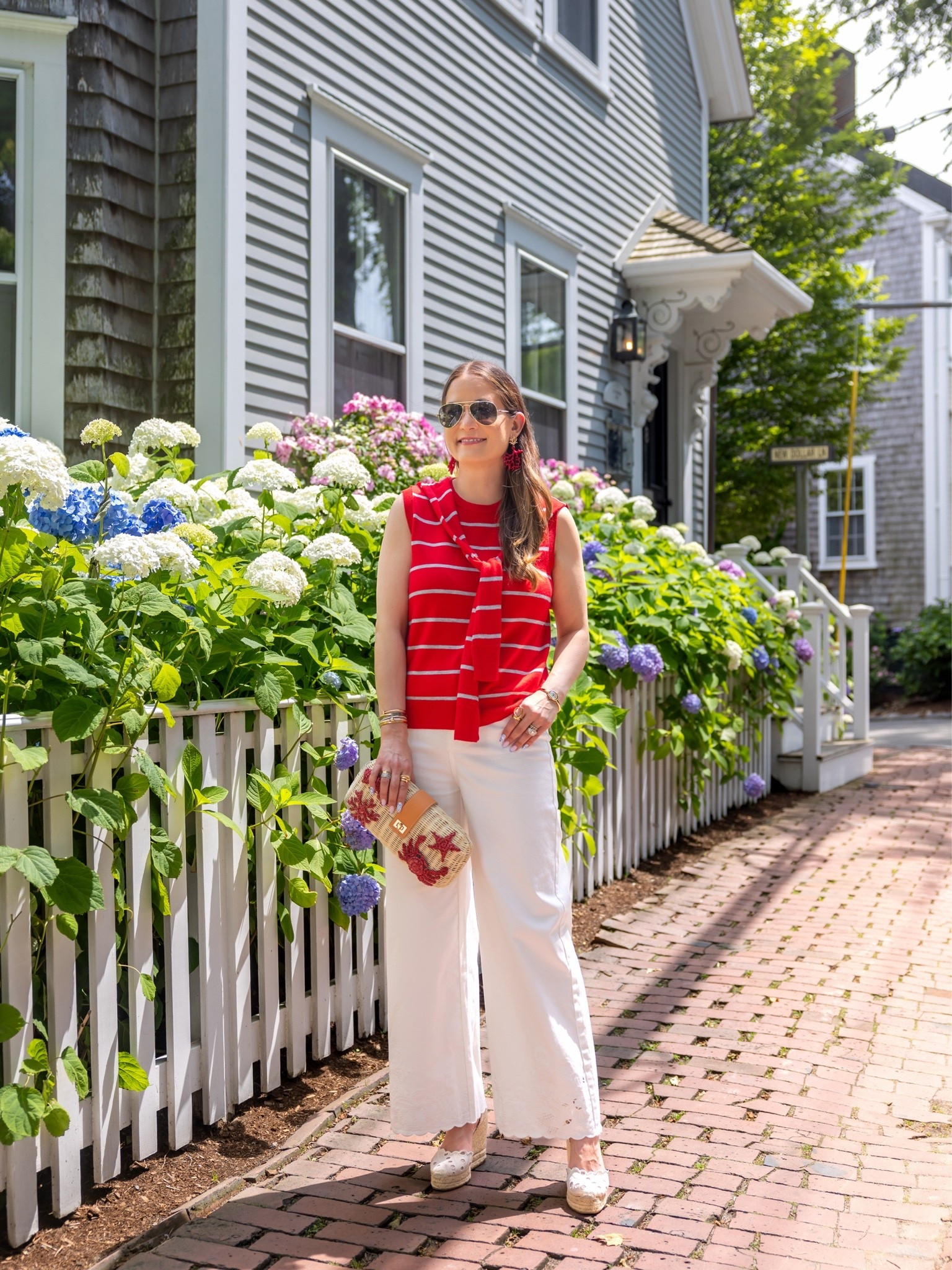 I love this red stripe sleeveless sweater shell with a built-in faux over the shoulder sweater detail from Red Dress paired with these white embroidered hem wide leg jeans and lobster rattan clutch

#LTKootd #LTKOver40 #LTKSeasonal