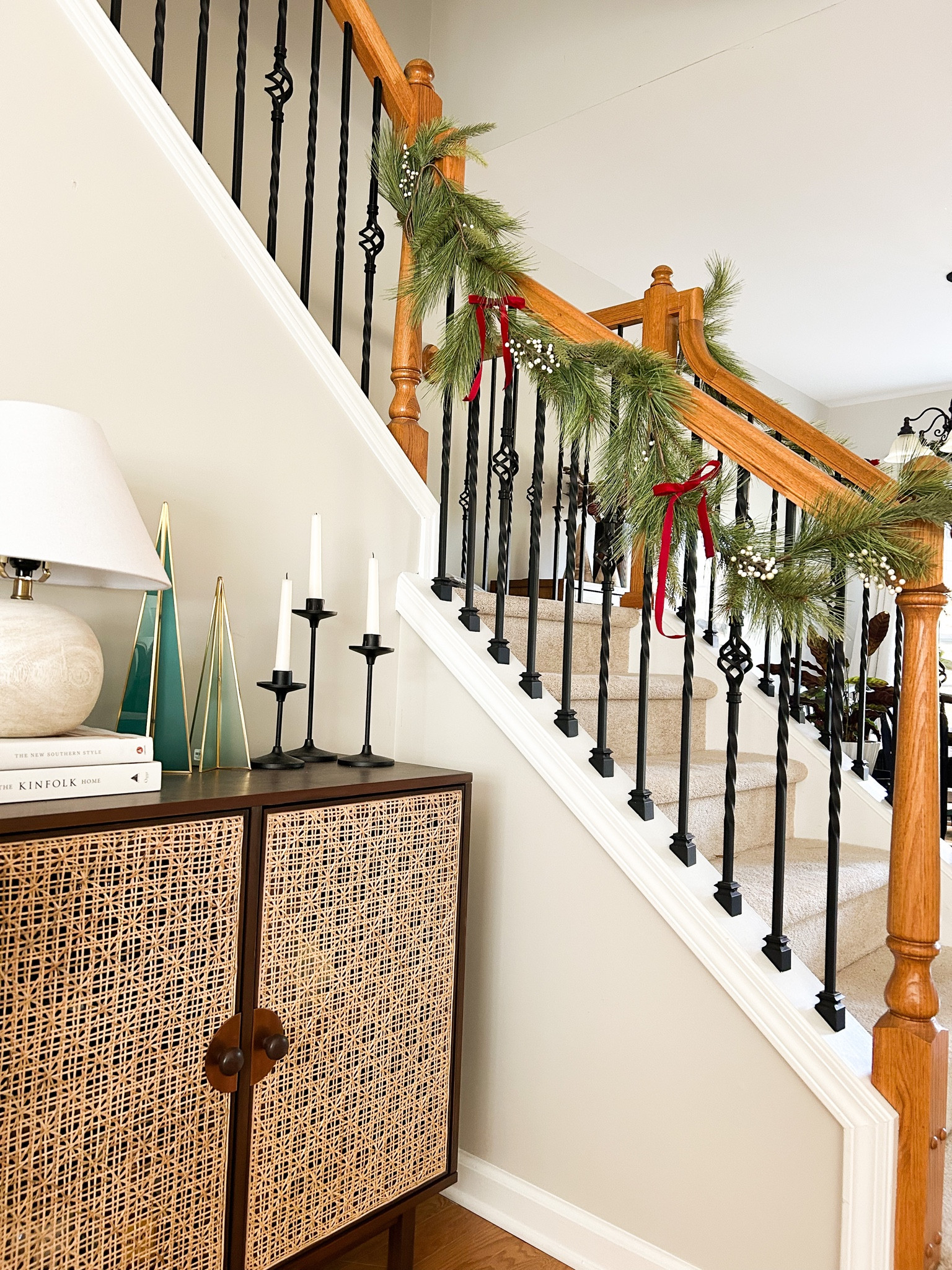 Bar cabinet
Christmas decor
Garland
Velvet ribbon
Staircase
Candlesticks 
Coffee table books
Small lamp
Home decor
Transitional
Jungalow
Wine glass
Glass Christmas trees

#LTKhome #LTKHoliday #LTKSeasonal