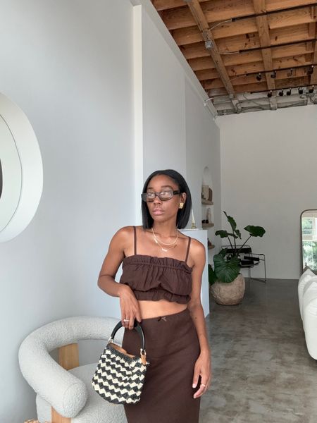 The cutest two piece skirt and crop top set. Mini black and tan raffia bag for spring and summer. Gold earrings. Vacation outfit 

#LTKItBag #LTKStyleTip