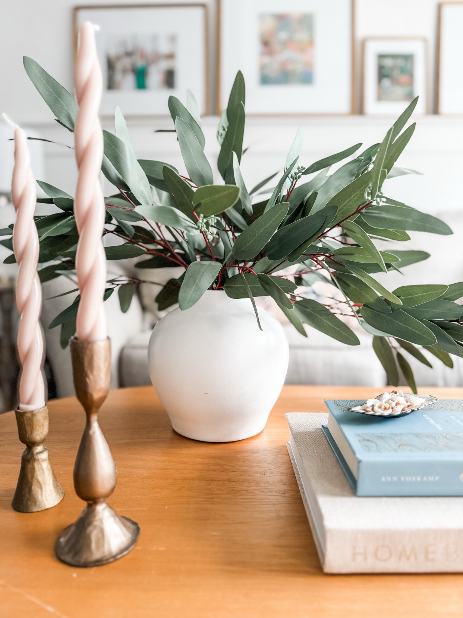 Spiral spring pink taper candle
Gold candle holders
Seeded eucalyptus stems
Coffee table decor
Coffee table book
Oval coffee table
Aged ceramic vase 

#LTKSeasonal #LTKStyleTip #LTKHome