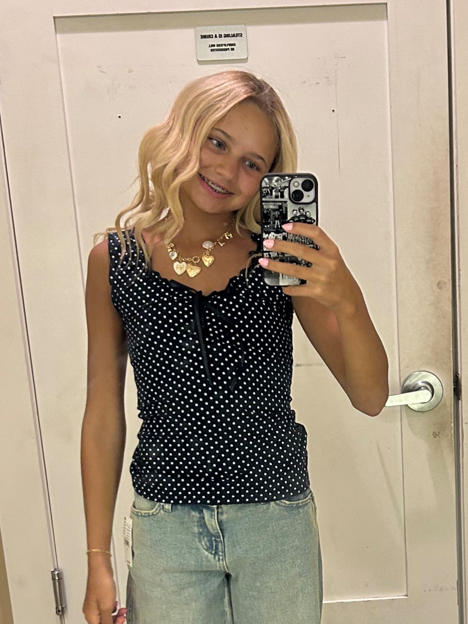 The Black Polka Dot top  brings a feminine flair to your everyday look. This charming piece has a polka dot print with a satin bow front detail, making it a versatile addition to your wardrobe for both casual and dressed-up occasions.

Polka dot print top
Scoop neckline
Lettuce-edge trimming
Wide fixed straps
Bow tie front detail
Regular fit
96% cotton, 4% elastane
Machine washable
One size fits most