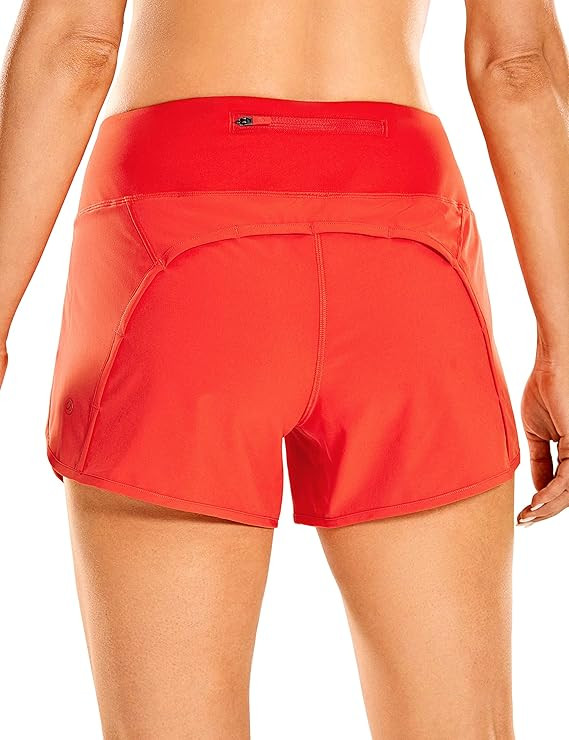 CRZ YOGA Women's Mid-Rise Quick-Dry Athletic Sports Running Workout Shorts with Zip Pocket - 4 In... | Amazon (US)