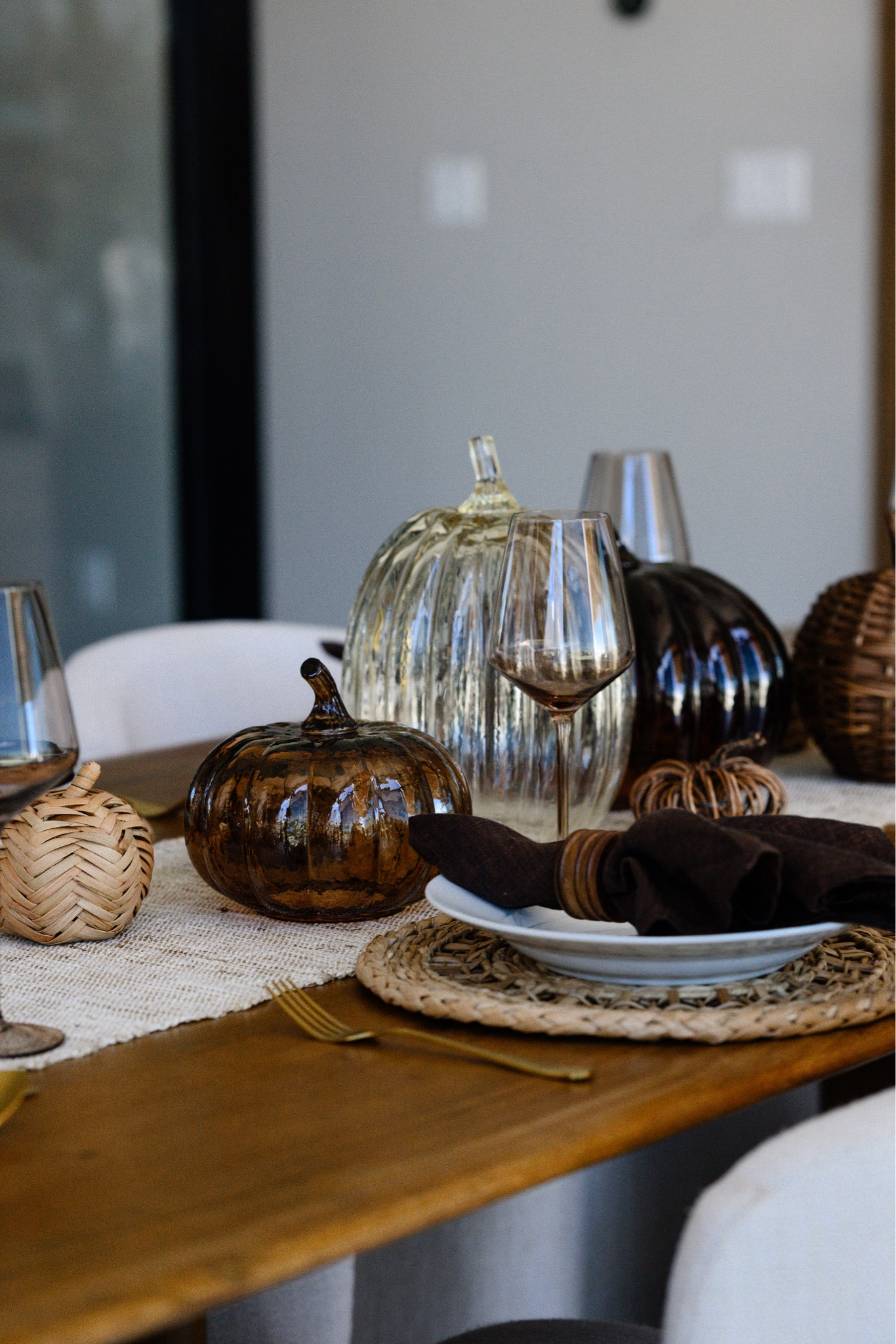 Fall tablescape 🍂 Glass pumpkins, woven accents, and chocolate napkins make the coziest setup for Thanksgiving or a fall dinner party! Everything is so easy to mix and match 🤎 

 #LTKover40 #LTKhome #LTKSeasonal