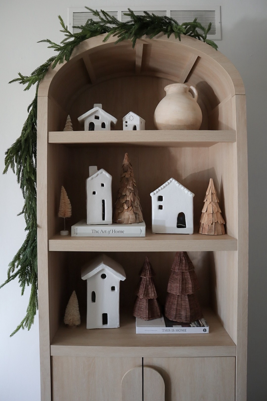 Arched bookcase decorated for Christmas 

#LTKHome #LTKSeasonal #LTKHoliday