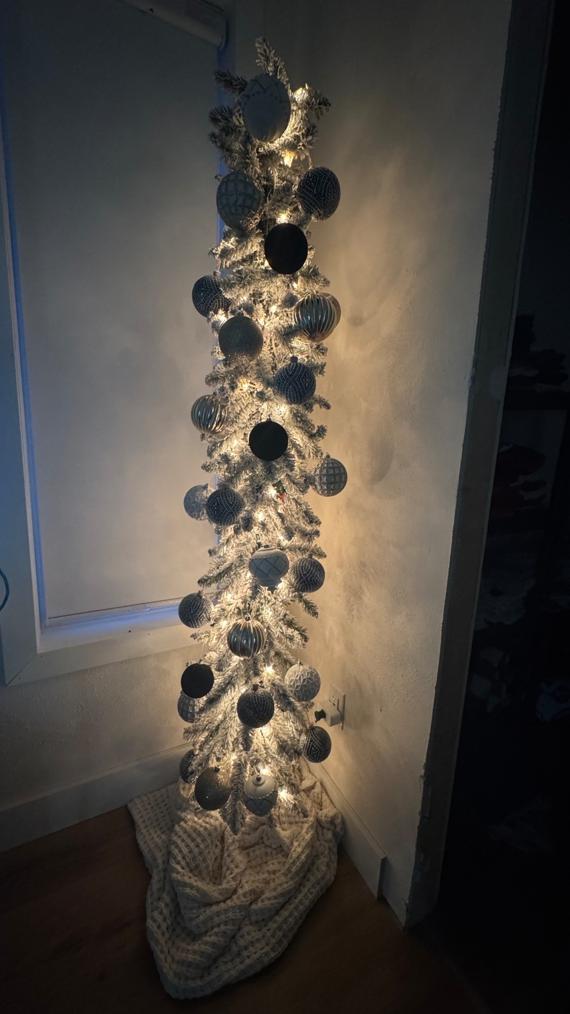 This skinny flocked tree in our bedroom has quietly become one of my favorite little things during the holiday season. Every night when I crawl into bed, the soft glow from the lights fills the whole room in the prettiest, calmest way. The snowy branches, the simple ornaments… it all just gives the most peaceful vibe.

It’s such a small corner of the room, but it makes the biggest difference. There’s nothing like ending the day with that warm, quiet glow. Linking the tree, the ornaments, and a few cozy bedroom touches on LTK. ✨🩶

#ltkhome #ltkit #holidayhome #christmasdecor #flockedtree

#LTKdayinmylife #LTKHoliday #LTKHome