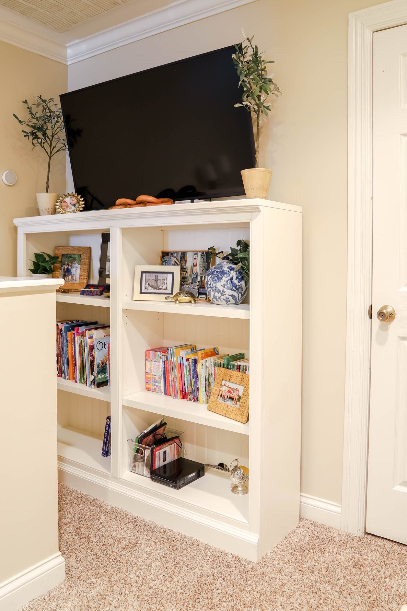 This low bookcase is perfect under our wall-mounted TV in our bonus area. It has nicely finished holes for cables and a lovely bead board backing.

#LTKHome