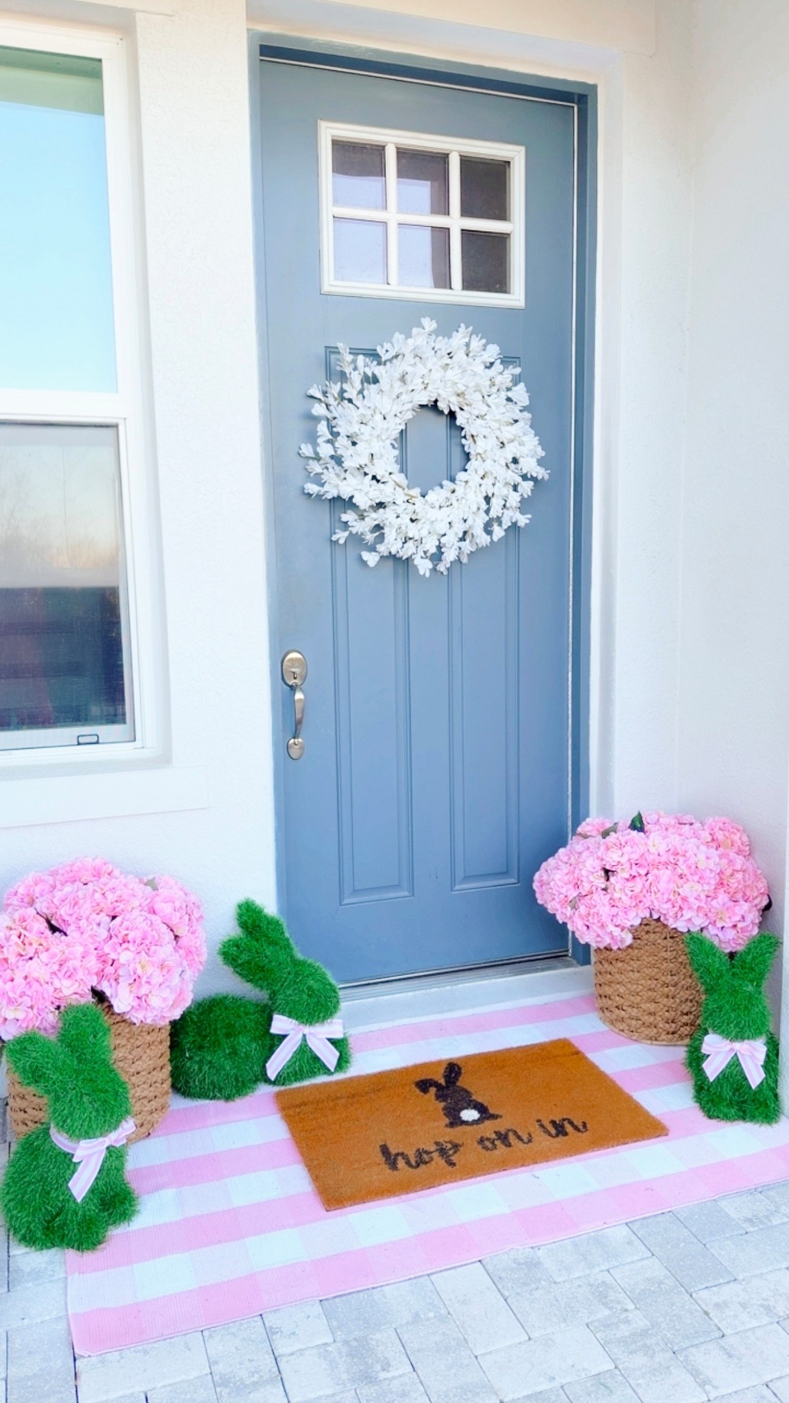 Spring Porch + Spring Patio Decor - pink artificial hydrangea flowers styled in a woven basket with adorable bunny topiaries, a matching pink plaid mat, spring welcome mat, + spring wreath for the front door. This is an easy way to decorate your home for spring, Easter, + summer! HURRY!!! The Easter bunny topiaries will SELL OUT! 

The fake hydrangeas come in a variety of spring colors. This only took me a few minutes to put together and decorate our front porch/ patio. I arranged the hydrangea flowers into the foam discs and then placed each set in a basket.

#LTKSeasonal #LTKHome #LTKSaleAlert
