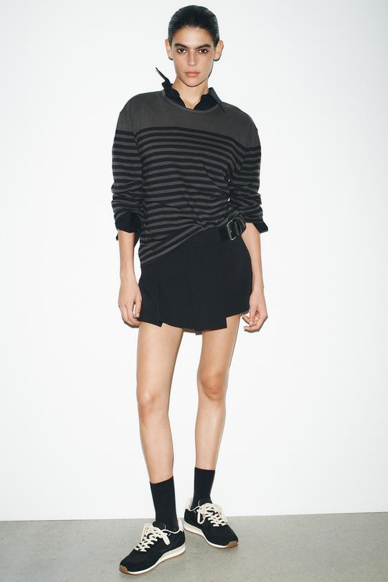 Sports running-style shoe. Topstitching detail on the body and color-contrast back. Lace-up closu... | Zara US