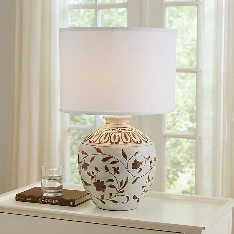I love this lamp from Ballard Designs! 

A classic urn shape and hand painted with a brown floral design. 

It definitely has a vintage and cottage style look, which I love. 

You could even use a different shade if you want to change it up. 

I think a woven shade or even a patterned shade would be so good! 

20% sale happening now. 

Ballard Designs • table lamp • cottage style • Nancy Myers style 

#LTKSaleAlert #LTKHome #LTKSpringSale