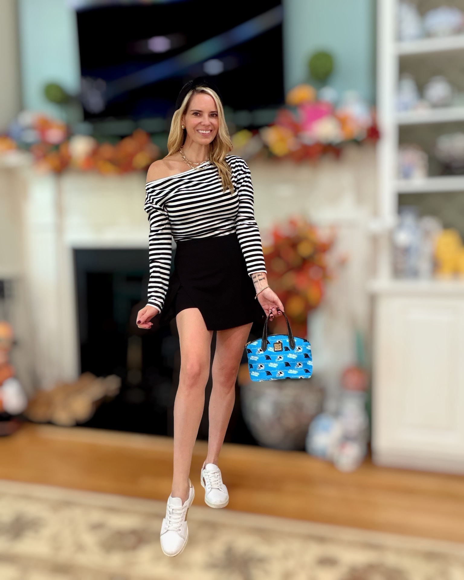Fall Football Game Day Style 🖤🏈💙

A little preppy, a little sporty, and definitely not your typical game-day look! 🏈✨ I’m loving this black-and-white striped one-shoulder top paired with a flirty black skort and white sneakers for an easy, feminine take on football season. The Panthers bag adds the perfect pop of team spirit 💙🐾

And because I can’t resist a little extra styling… gold jewelry, a black bow headband, and this adorable football bag take the whole look up a notch. 🤍✨ Perfect for tailgates, game days, casual fall outings, or cheering from the sidelines!

Preppy football outfit, women’s game day outfit, football season style, fall transition outfit, sporty chic outfit, black and white striped top, black skort outfit, game day fashion, Southern style, preppy fall fashion, women over 40 style, football fan outfit, tailgate outfit.

#LTKOver40 #LTKSeasonal #LTKActive