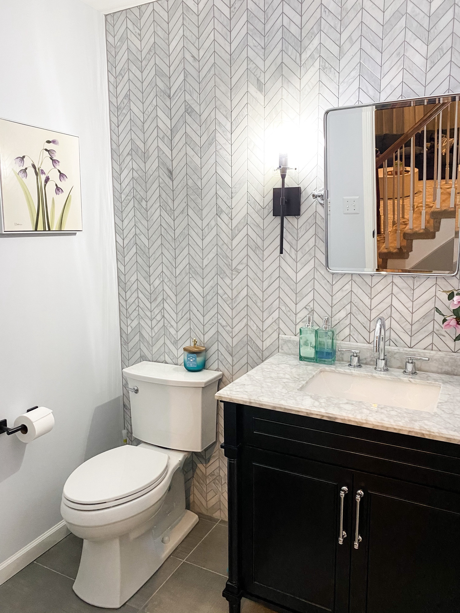 ✨Powder Rooms ✨ are where your personality shines! Whether moody, welcoming, glamorous and so on, powder rooms are a great way to increase the vibrance of the home. When doing this powder room, we went with a chevron marble tile for an accent wall, a pivot mirror (currently on clearance!) and contrasted the colors of the space with a black finish vanity. The before and after of this space is simply jaw dropping and stunning 🤍🖤

#LTKSaleAlert #LTKHome #LTKStyleTip