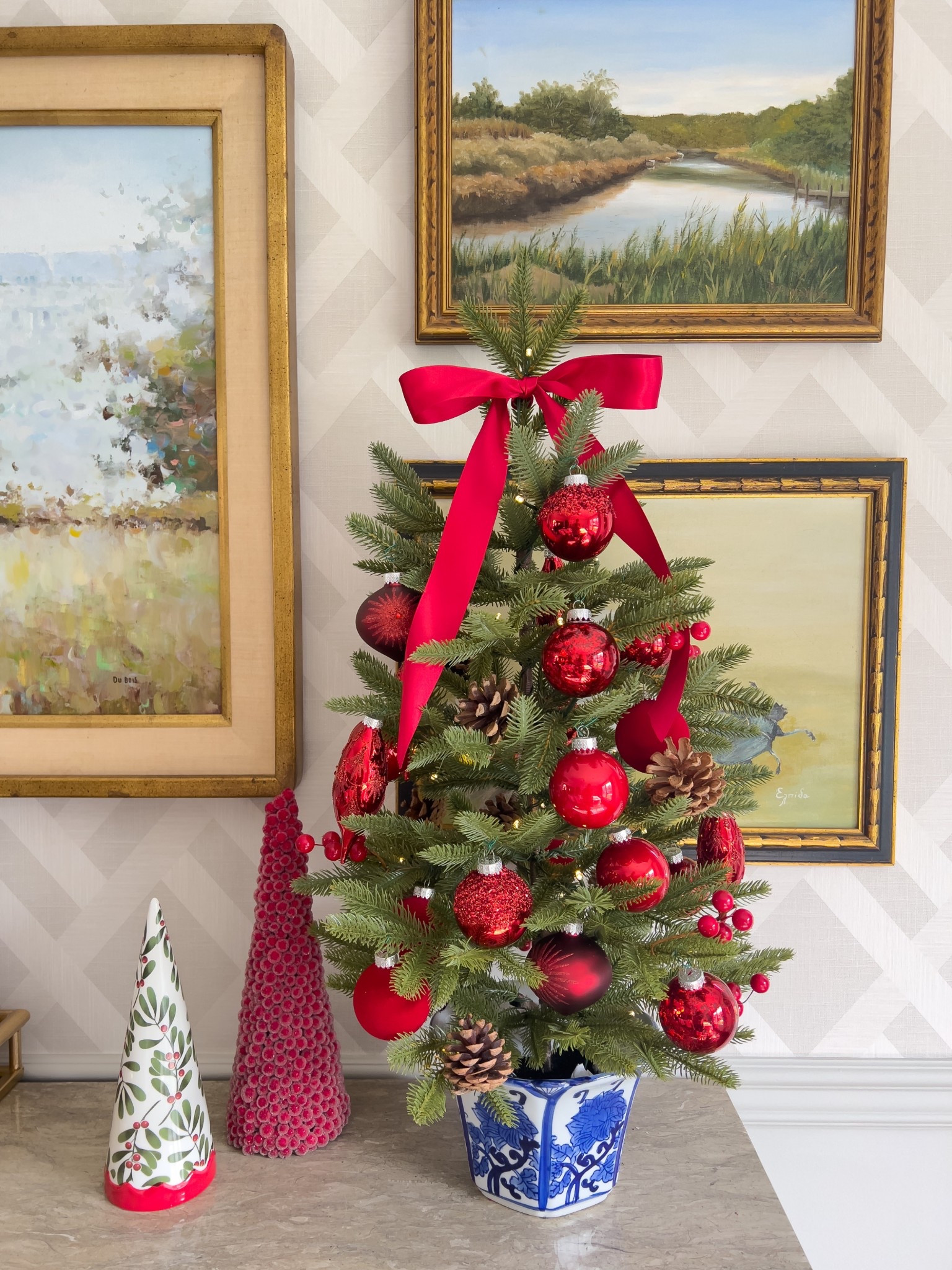 Holiday tree redesigned in a chinoiserie pot and decorated with stain ribbon and glass ornaments. 

#LTKHome #LTKSeasonal #LTKHoliday