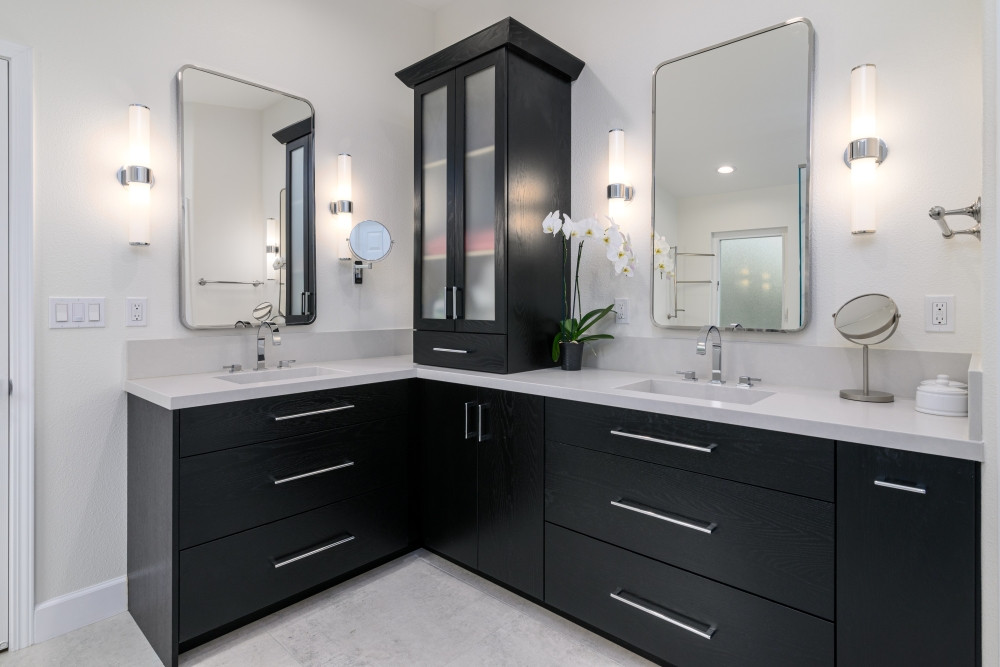 A sleek and sophisticated transformation. This bathroom remodel features striking black wood grain vanity cabinets paired with the timeless elegance of chrome hardware. The matching chrome mirror and frosted glass sconces add a modern touch while the crisp light gray countertop brings balance and brightness.

#bathroomremodel #bathroom #bathroomdesign #bathroominspiration #bathroomrenovation #bathroomgoals #bathroomideas #bathroomstyle #modernbathroom #primarybathroom #primarybathroomdesign #bathroomdetails #bathroomvanity #bathroomreno #chromefixtures #bathroomfaucet #bathroomsconces #bathroomlighting
 

 #LTKHome