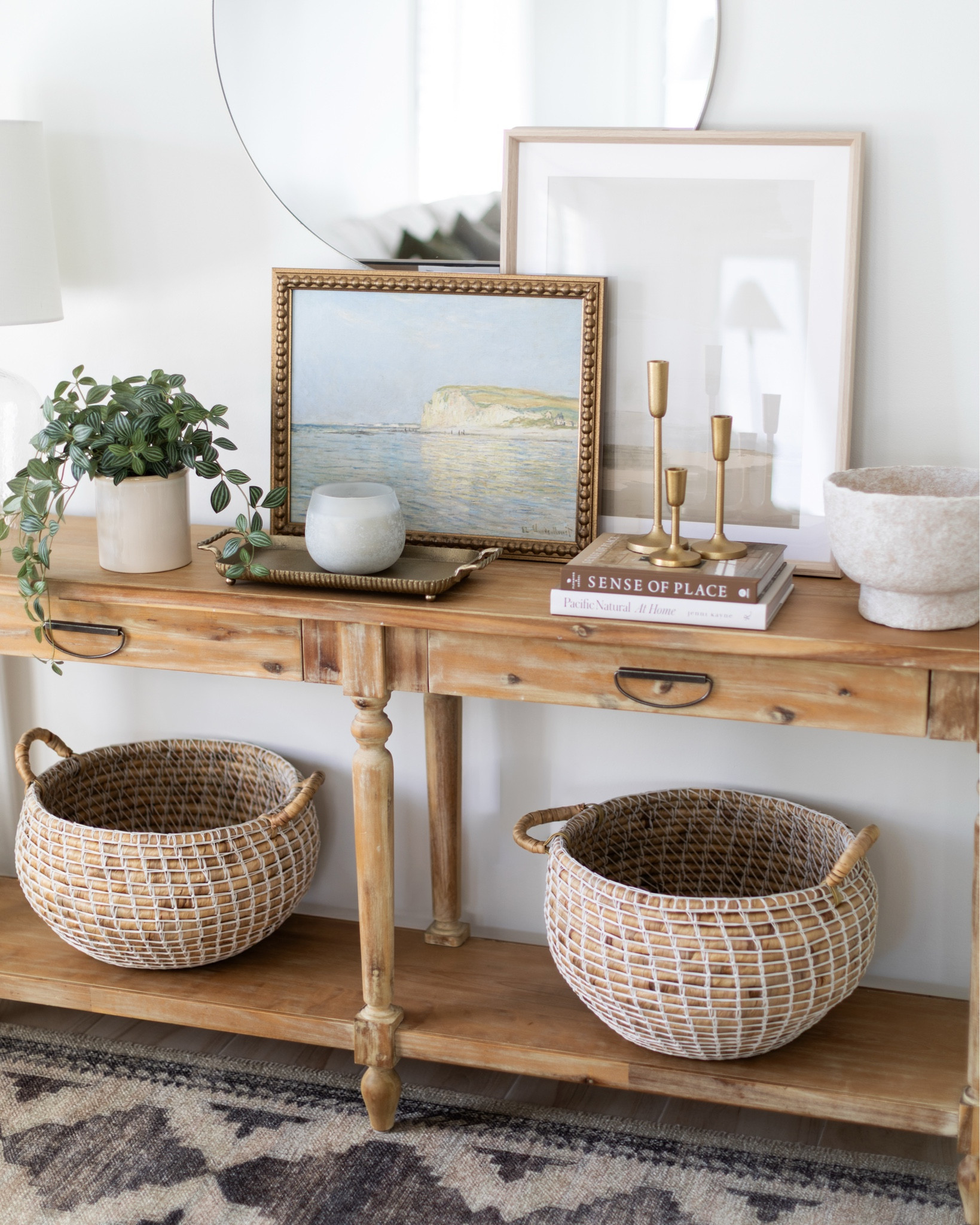 A light coastal style for this console table for Spring. One of my favorite wooden console tables from World Market, wall art and a beautiful round mirror.

#LTKSaleAlert #LTKSeasonal #LTKHome