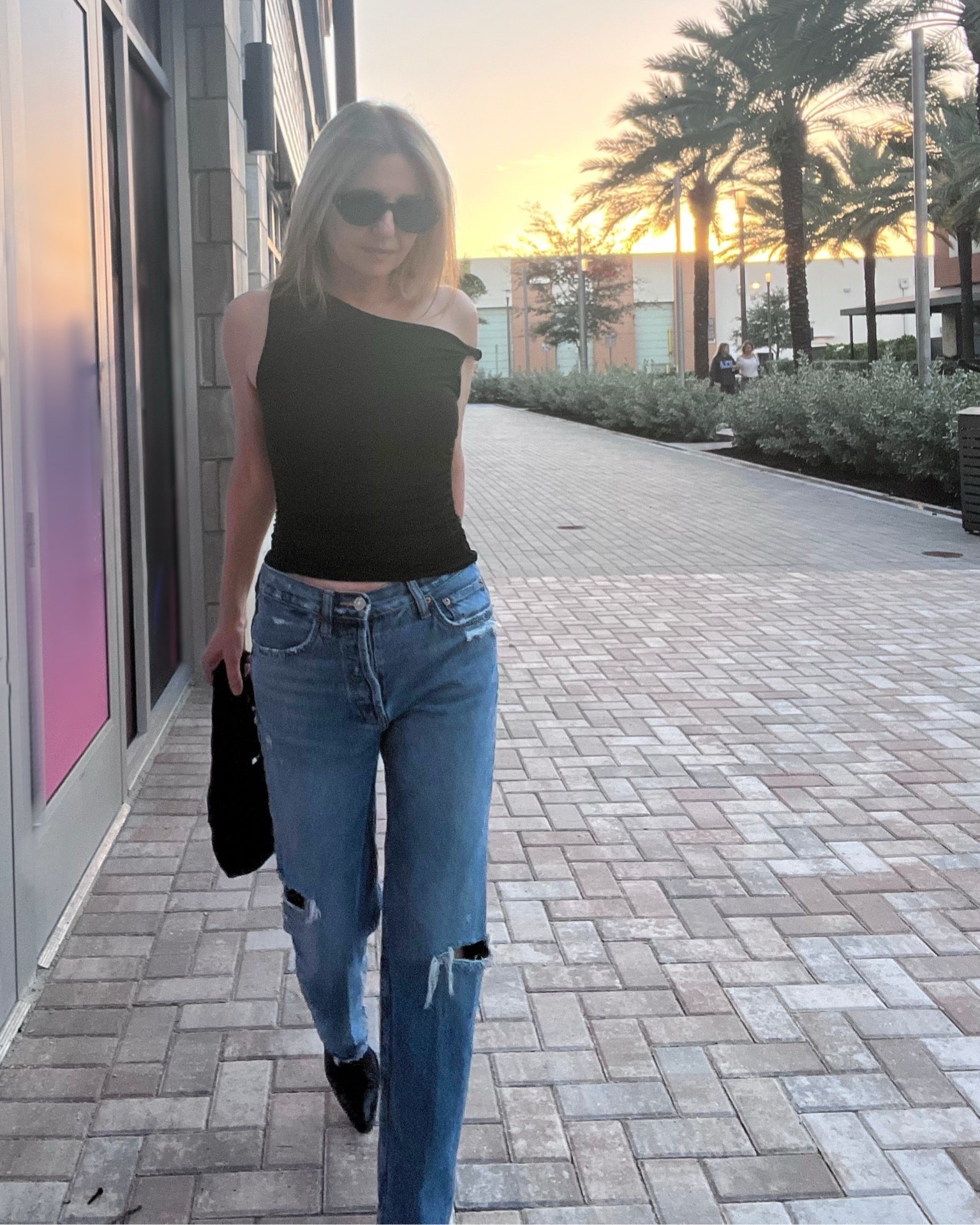 Different black top + blue jean look. Distressed denim in medium rinse w an off the shoulder stretchy jersey material top. Black western ankle boots on bottom w a black round shoulder bag. 

#LTKootd #LTKSeasonal #LTKSaleAlert