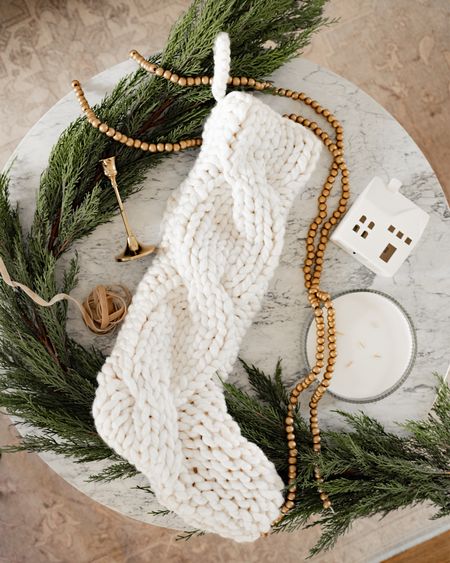 White cable knit stocking, faux cypress Christmas garland, gold bead garland, white ceramic Christmas village. 

#LTKSeasonal #LTKHoliday