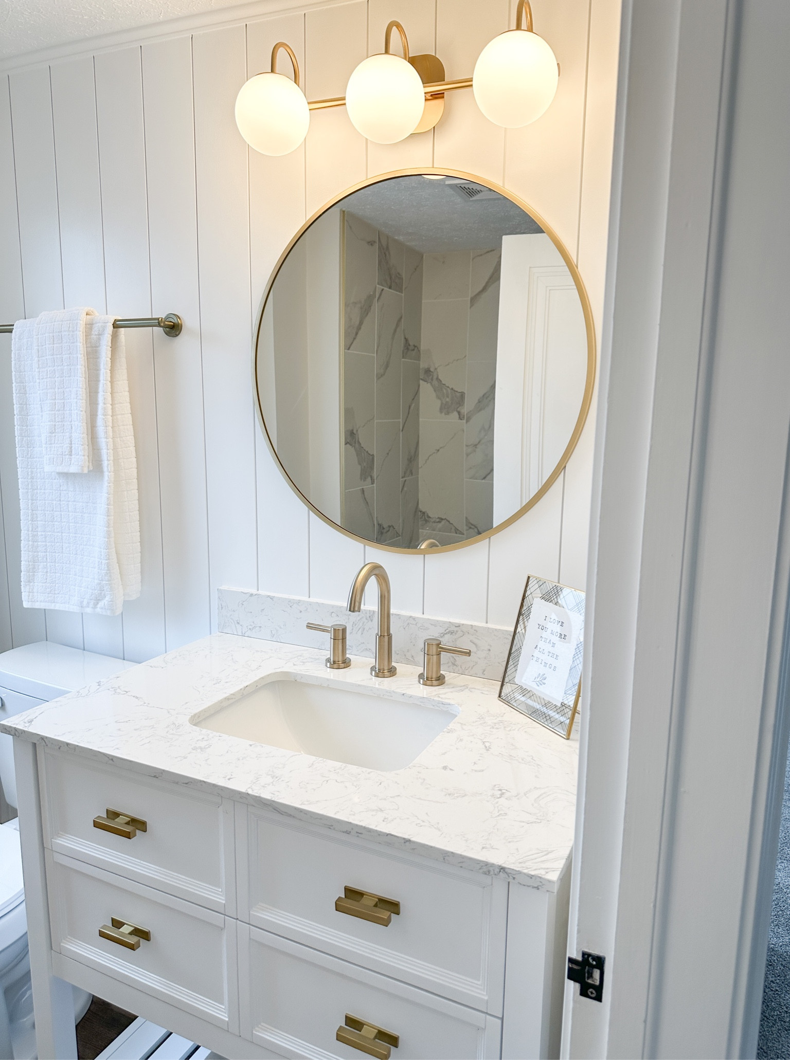 Bathroom remodel // vanity // round gold mirror // vanity light // marble look // gold faucet // gold shower head 

#LTKFind #LTKunder100 #LTKhome