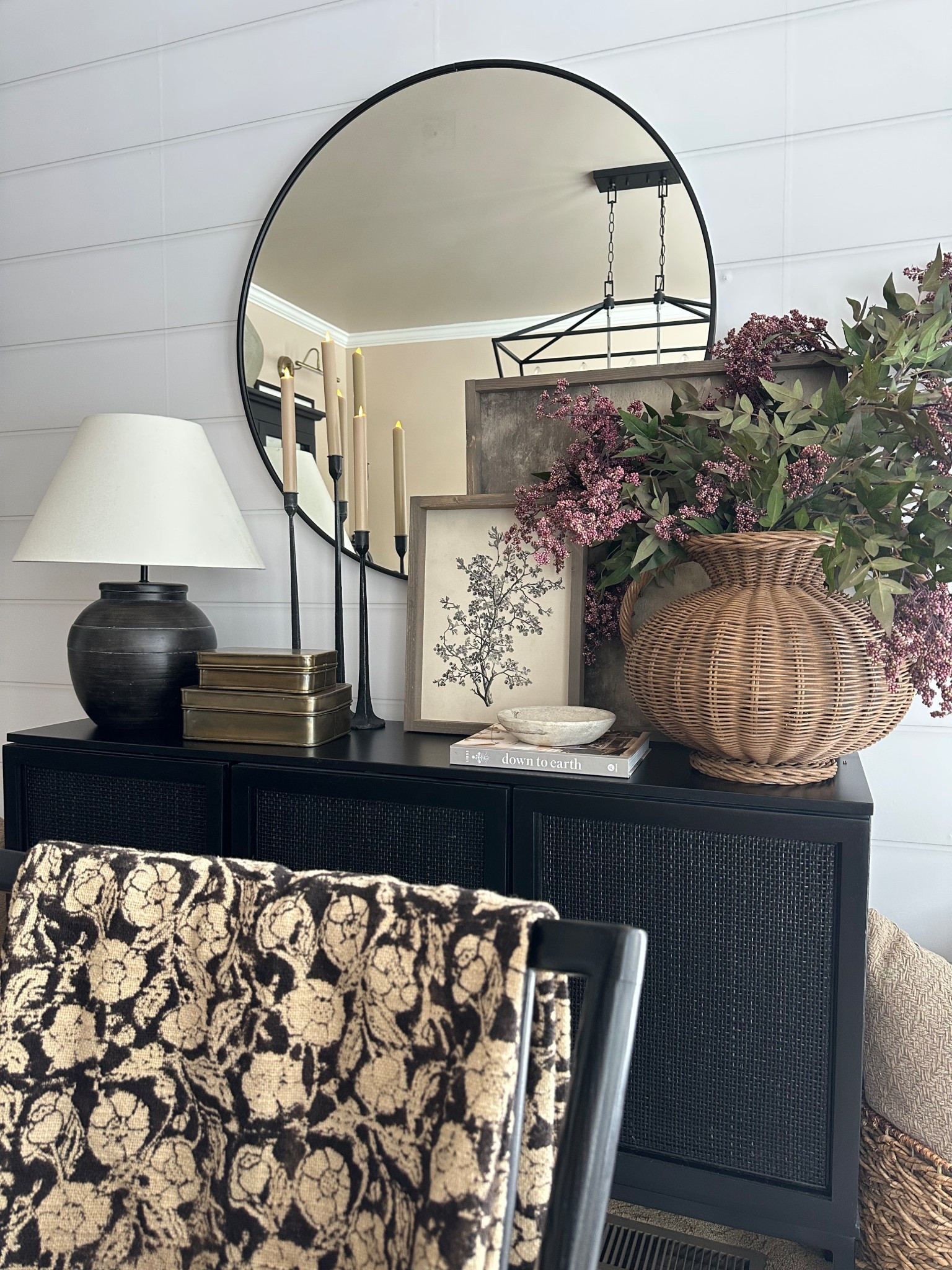 Modern Organic Sideboard Decor with Round Black Mirror

Follow @farmtotablecreations on Instagram for more cozy home inspiration.

This sideboard vignette brings together warm neutrals, layered textures, and timeless accents for a clean modern organic look. The round black mirror adds depth and contrast, while stacked art, soft candlelight, and a woven wicker vase filled with faux berry stems keep the styling grounded and inviting. It’s a simple way to create a statement moment without overwhelming the space—perfect for a dining room, entryway, or living area.

The build-a-sign frame feature is 15% off with my code FARMTOTABLE.
For reference:
Botanical Print 12x16
Abstract Art 24x24
Both in Briarsmoke stain

#sideboarddecor #roundmirror #consoledecor #modernorganic #neutraldecor #homedecor #interiorstyling #wovenaccent #candlesticks #wallart


#LTKSaleAlert #LTKHome