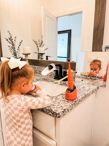 Self efficient toddler bathroom set up (Montessori inspired)

Faucet extender and the faucet handle pulley has been a huge game changer for her to be self efficient and she loves it! 
I had to add a mirror so she could see her self as she’s short like her mama :)

TOOTHBRUSH:
The sonic one for a older toddler with all teeth. I linked our favorite baby tooth brush the one we use now for AJ who is 15 months old. 

For our potty training toilet setup I’ll be putting a stair ladder on the toilet (that’s what we use downstairs while we are in the thick of potty training) until she really gets the hang of it then I’ll switch to a fold down adult and toddler set option (linked below) and have her use the steps, right now we use steps and the bnjour toilet seat.  

I also added a travel potty seat when out and about it folds up!

#LTKkids