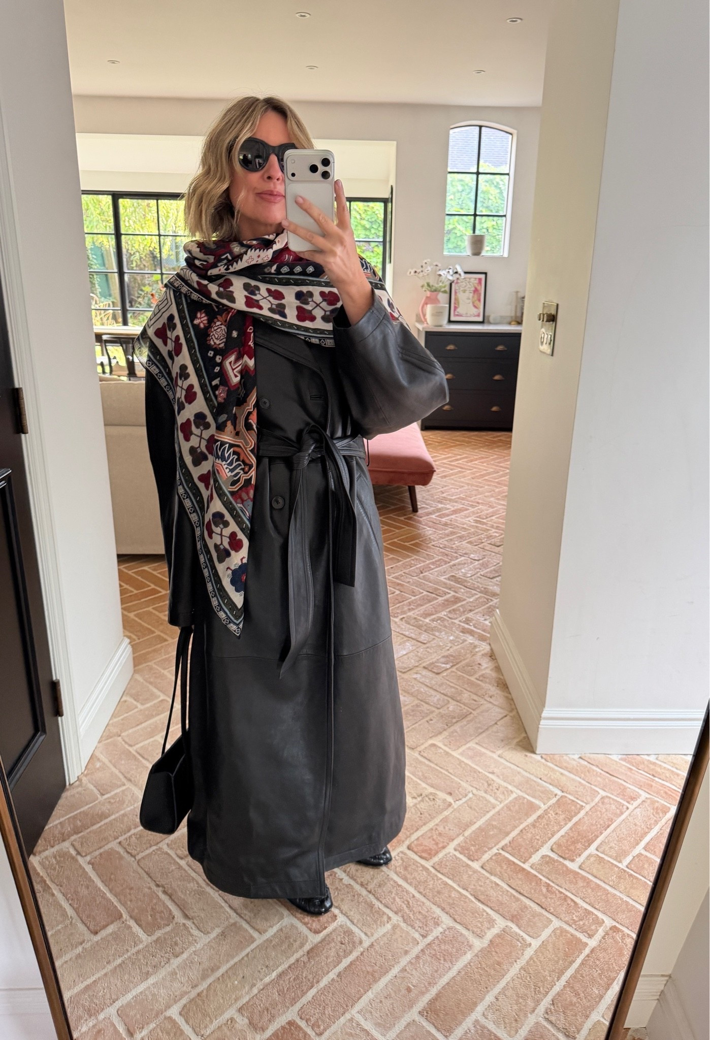 Printed scarfs are Autumn’s favourite accessory

longline leather trench coat, belted leather coat, printed statement scarf, patterned scarf, black leather shoulder bag, black cat eye sunglasses, statement outerwear, autumn transitional dressing, layered outfit, elevated basics, quiet luxury, monochrome styling, statement accessory, mirror selfie ootd, ltkstyletip, ltkseasonal, ltkfindsunder100, ltkitbag