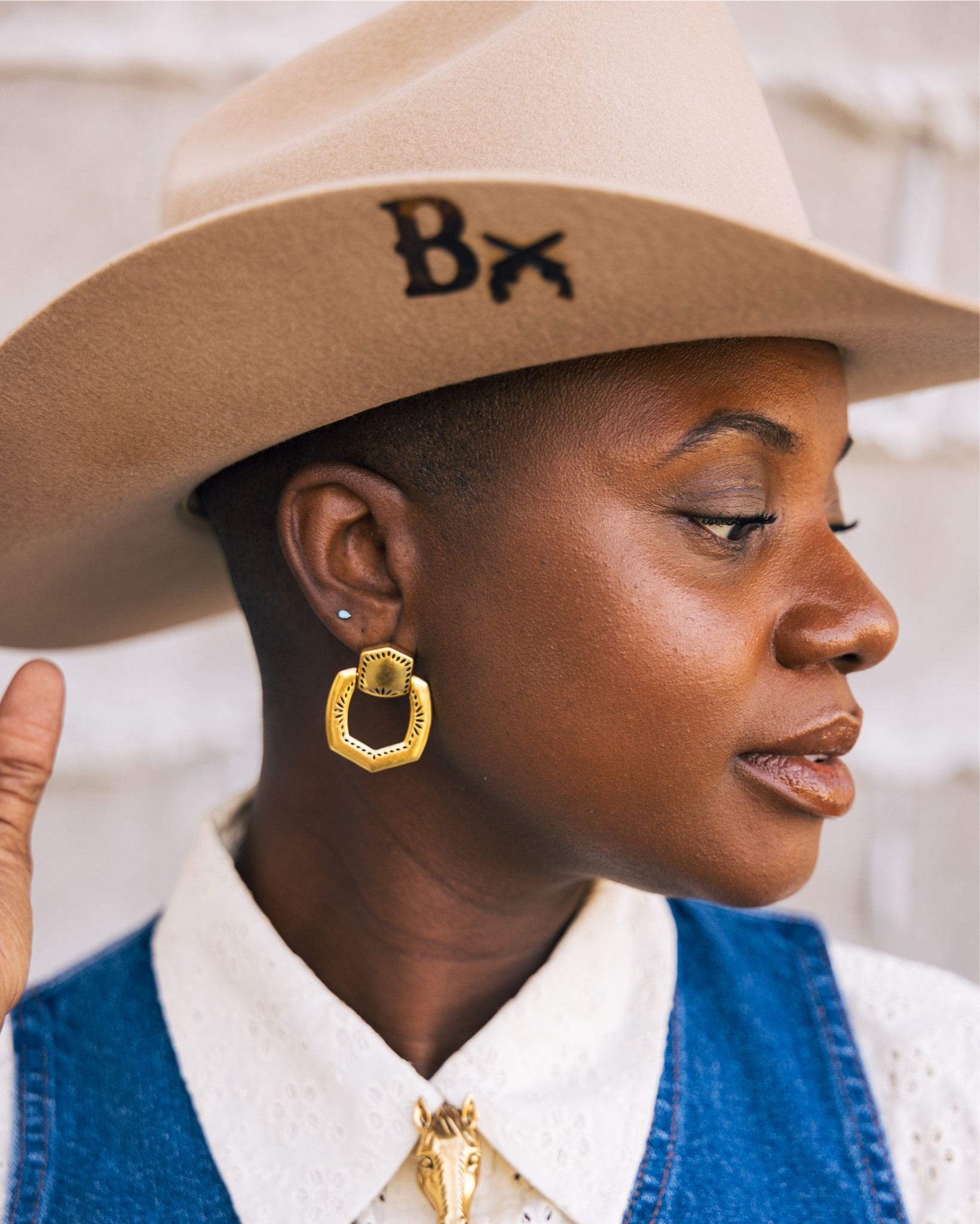 Western outfit for Rodeo season! Denim wrangler vest and skirt with gold buttons, brown western boots,vintage white button up shirt with eyelets and vintage gold earrings  all from YellowRose by Kendra Scott! 

#LTKootd