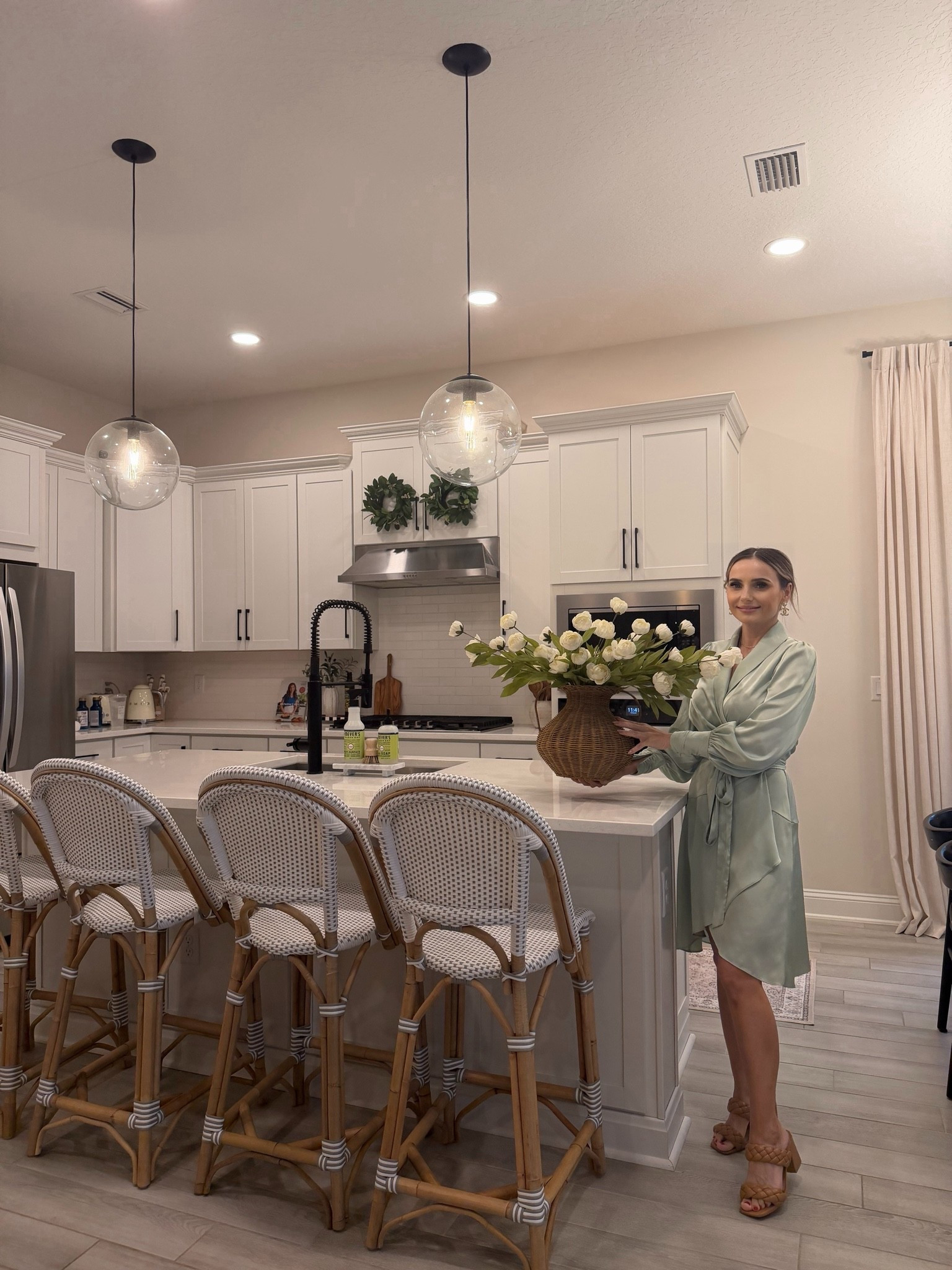 Kitchen refresh, but make it cozy. 🤍

One of my favorite ways to make our home feel fresh is adding beautiful faux flowers and warm, natural textures. These woven counter stools continue to be one of my favorite purchases, and this oversized vase with white blooms completely transforms the space.

Everything I’m wearing and everything in this kitchen is linked in my LTK, including my outfit, stools, vase, flowers, lighting, and more!

✨ Follow me on LTK for more affordable home finds and everyday style.

#LTKmomlife #LTKfoodie #LTKHome