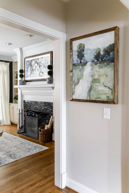 Follow Me art leads into my living room with my lovely rug and picture frame TV.

#LTKhome