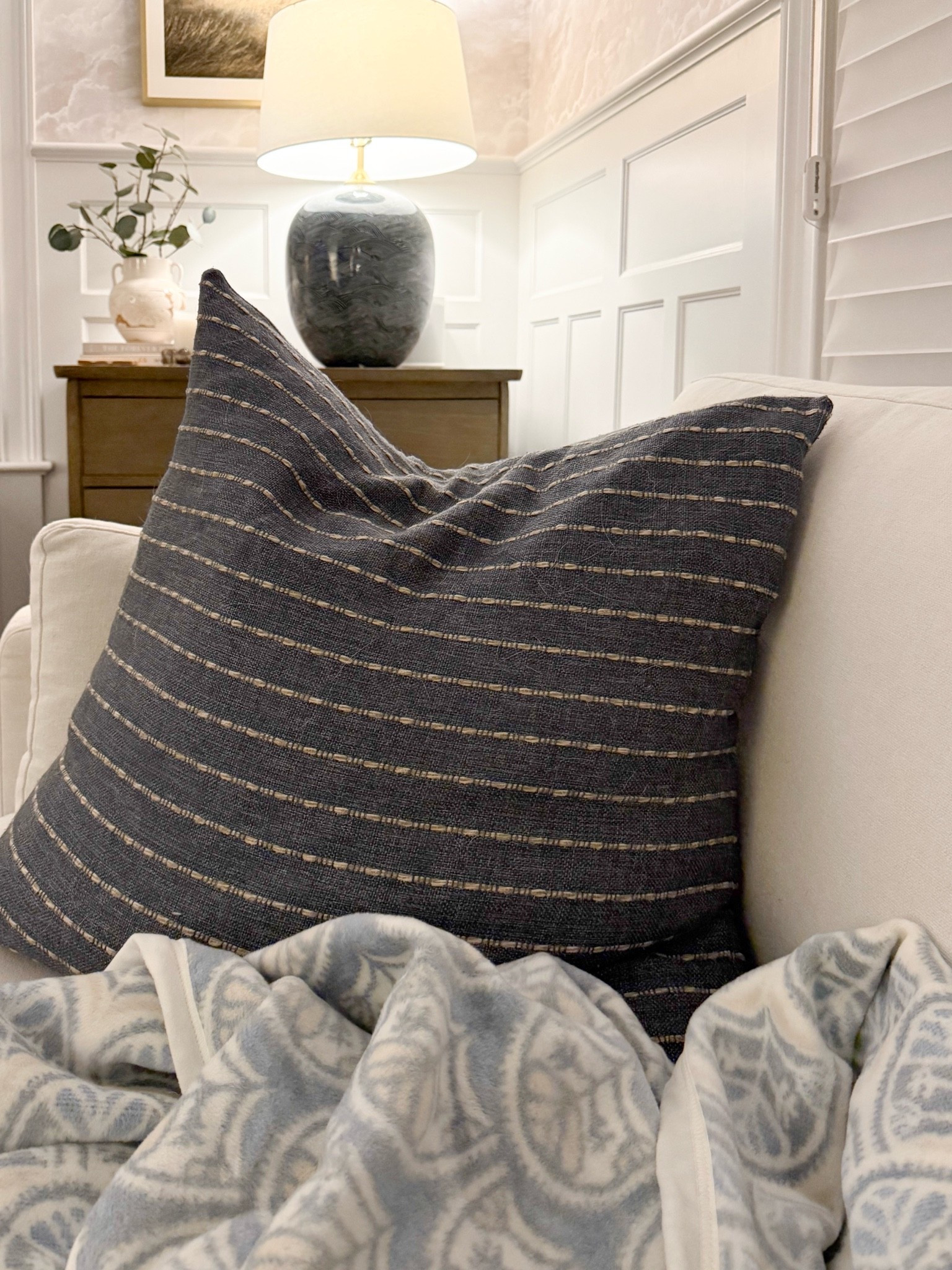 The coziest little corner for fall. I love the mix of the textured blue pillow, soft patterned throw, and warm wood tones. Such an easy way to make a room feel extra inviting as the temperatures cool down.

fall home decor, cozy fall decor, fall pillows, textured throw pillow, patterned throw blanket, cozy living room, seasonal home accents, neutral fall decor, layered home decor, blue and white decor, autumn home styling, girlonthehudson