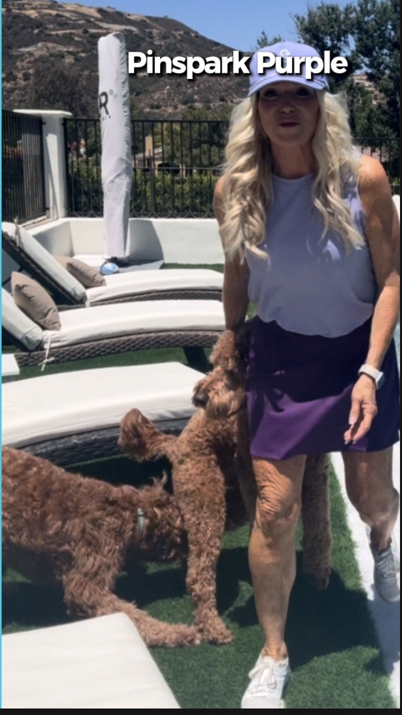 Backyard dog toy duty before the golf tournament practice round. 💜⛳️

Wearing my Pinspark purple skirt, lavender sleeveless cooling shirt, and Swanies baseball cap — cute, comfy, and ready for golf after a little fun with the dogs. The best kind of warm-up!

#LTKStyle #GolfOutfit #Pinspark_official #GolfSkirt #GolfStyle #BackyardFun #DogMomStyle #PracticeRound #AthleisureStyle #EverydayWithRhonda