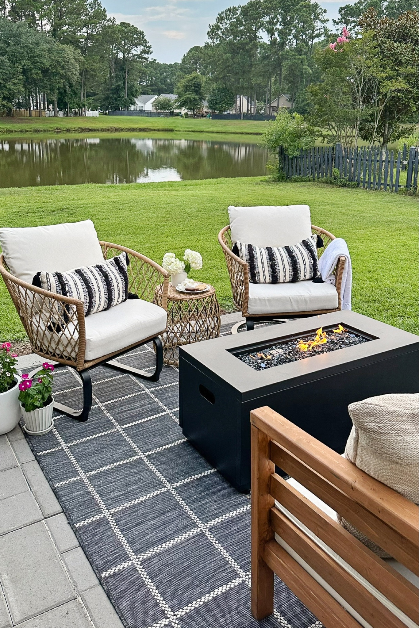 Outdoor living space with outdoor furniture and decor from Walmart, smokeless fire pit, wicker outdoor chair and table set, throw pillows

#LTKSeasonal #LTKHome #LTKSaleAlert