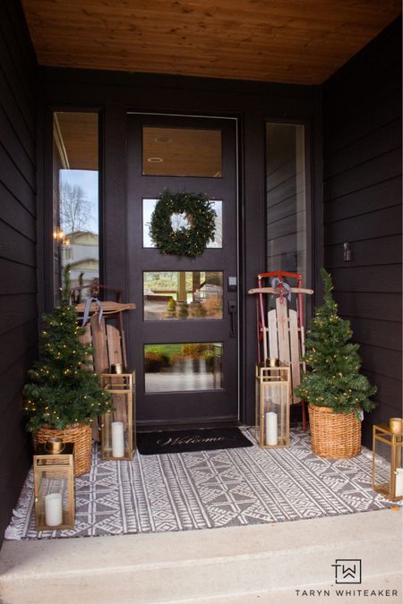 Moody Christmas front porch with black front door, vintage sleighs and greenery. 

#LTKHoliday #LTKSeasonal #LTKhome