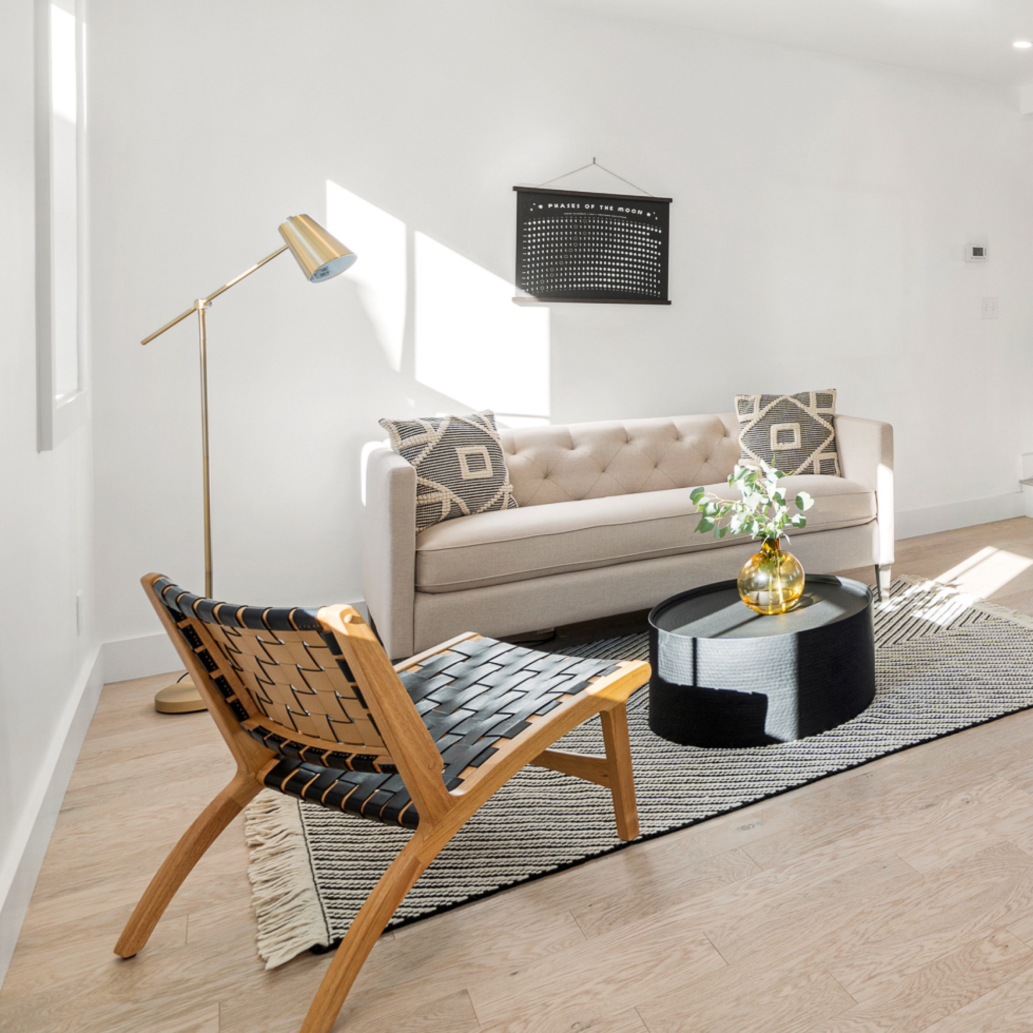 we loved how the living area at the #witchymodernhouse was a step lower than the kitchen. this elevation change gave the living room a peaceful, cozy feel. white walls, white oak flooring, and updated lighting really transformed the space into a large and inviting sitting area. #dwelloctober

#LTKhome