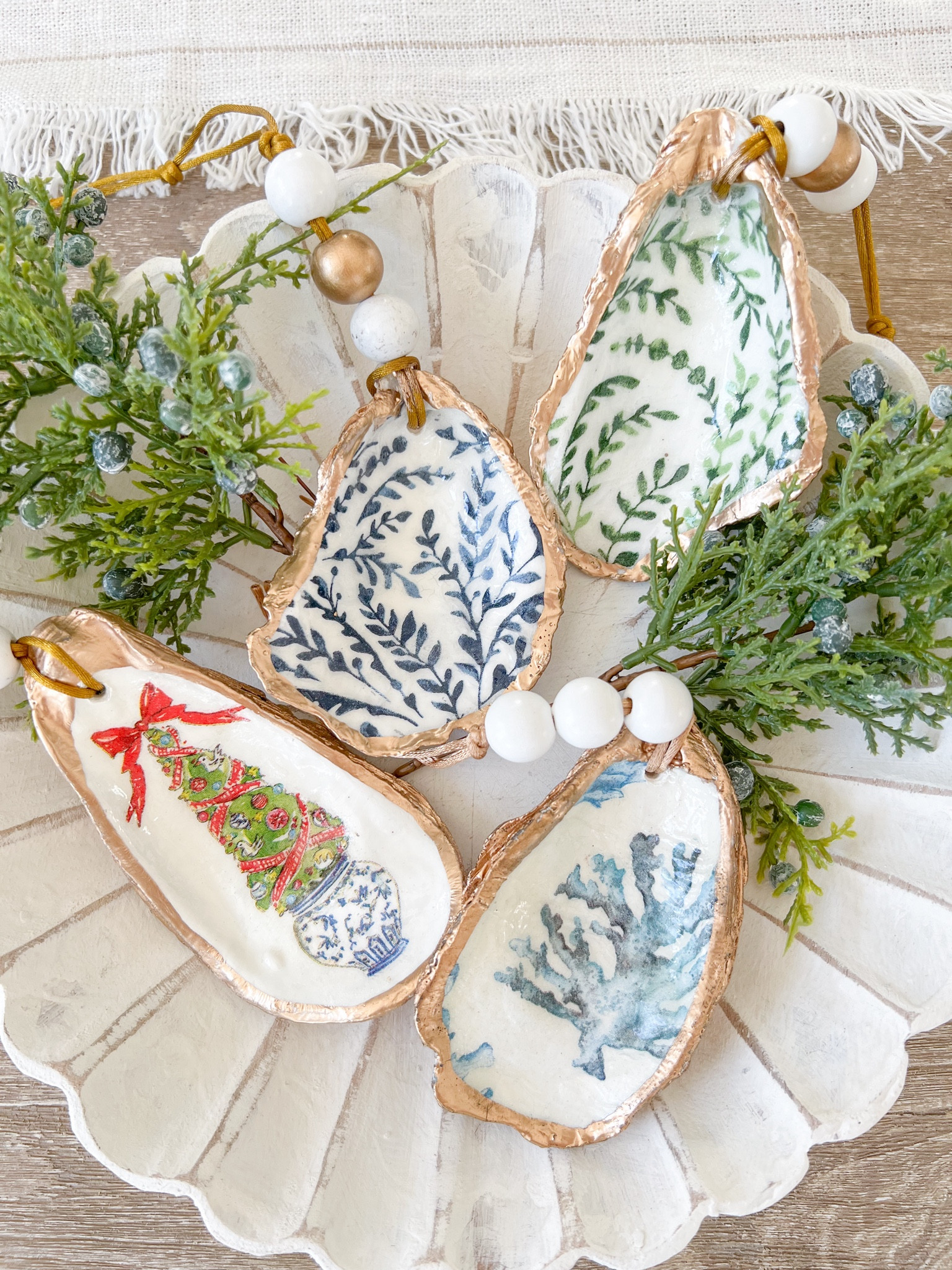 If you're looking to gift or add a few special ornaments to your tree this year, these oyster shell ornaments are beautiful! Choose from Serena & Lily inspired ornaments, or a more classic Christmas look!
-
coastal christmas decor, coastal christmas ornaments, oyster ornaments, serena & lily ornaments, hand-painted ornaments, handmade ornaments, Etsy decor, coastal home decor, beach house decor, blue and white christmas decor, gold ornaments, holiday ornaments, tree decor, coastal tree decor, locally made ornaments 

#LTKSeasonal #LTKHoliday #LTKhome