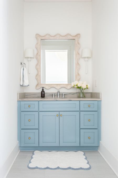 Our bathroom decorated for spring! We love the gold knobs on our blue cabinets, and I added these faux peonies, scalloped bath mat, and scalloped hand towel for spring! Also linking our white sconces and scalloped wood mirror. See our full spring home tour here: https://lifeonvirginiastreet.com/2024-spring-home-tour/.
.
#ltkhome #ltkseasonal #ltksalealert #ltkstyletip #ltkfindsunder50 #ltkfindsunder100 coastal decor, spring decorating ideas #LTKsalealert #LTKhome

#LTKSaleAlert #LTKSeasonal #LTKHome
