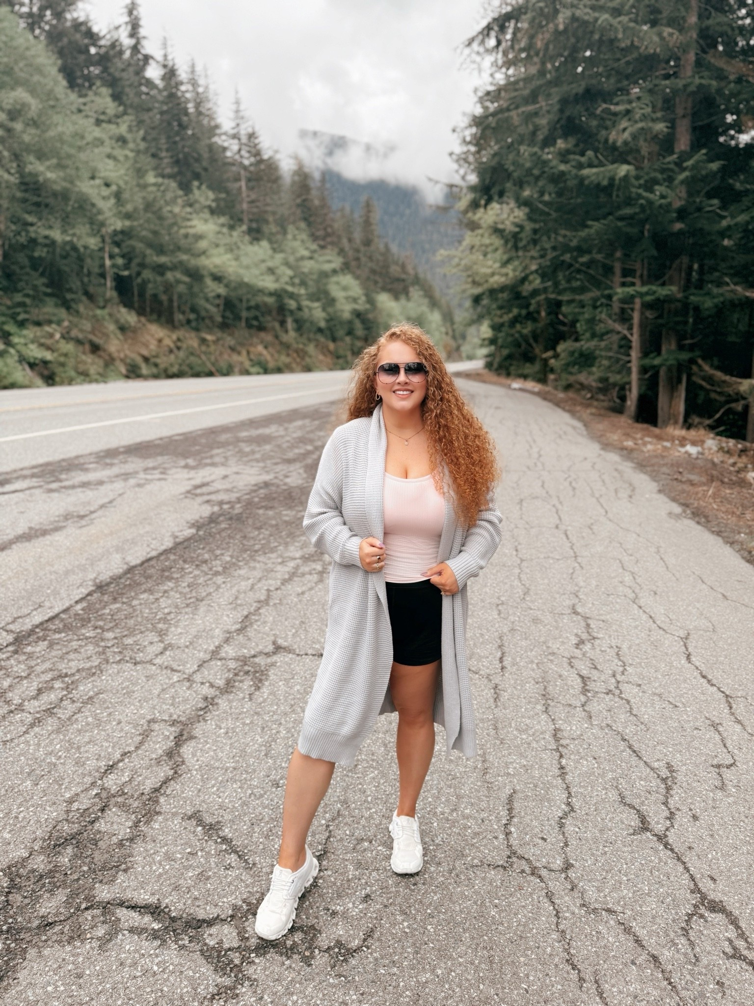 Moody mountain mornings just hit different 🌫️🌲 Kept it cozy and easy for a slow day exploring in this soft gray cardigan layered over a pink tank, black athletic shorts, and my fav on cloud sneakers for all the walking between views ✨ moody mountain outfit | cozy cardigan outfit | gray cardigan look | pink tank top outfit | built in bra top | black athletic shorts | on cloud sneakers | athleisure outfit inspo | travel athleisure | hiking inspired outfit | mountain vacation style | casual cute outfit | comfy travel outfit | outdoor outfit ideas | neutral cozy style | amazon fashion finds | sporty chic outfit | layered cozy look | vacation athleisure | scenic outfit inspo 🌫️

#LTKootd #LTKTravel #LTKMidsize