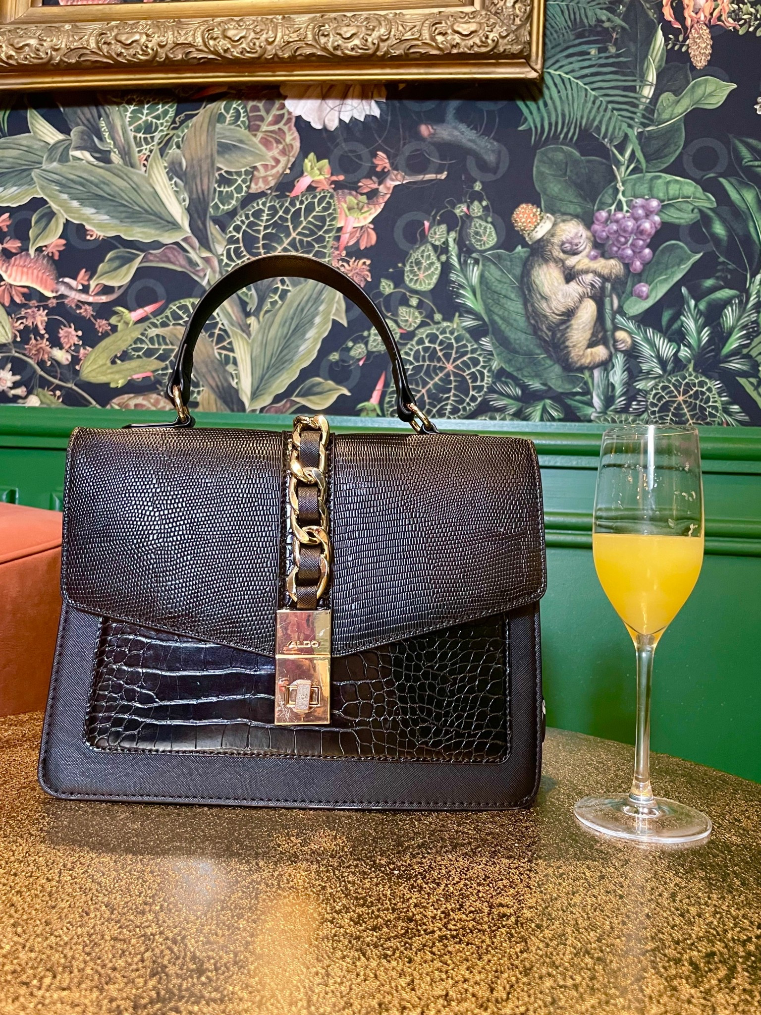 Brunch ready in this classic black, top handle handbag with exotic crocodile textures, sophisticated gold hardware, and a mimosa on deck. 


#LTKfoodie #LTKdayinmylife #LTKSaleAlert