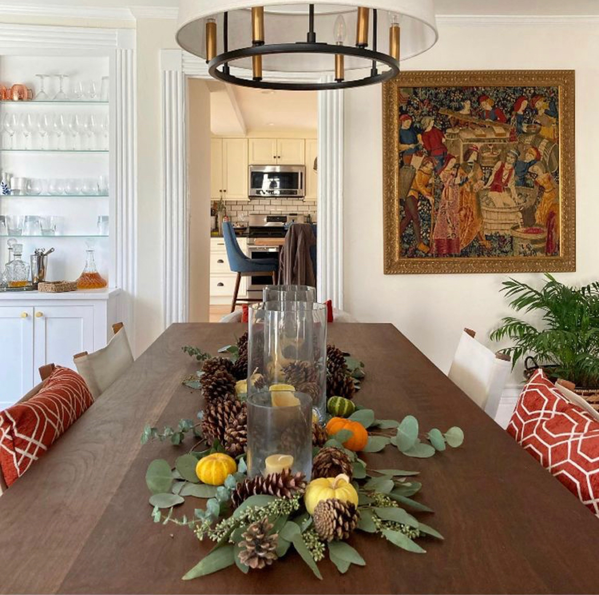 This is my favorite, easy thanksgiving table centerpiece. I use fresh eucalyptus but faux would work too and the pumpkins and pine cones add color and texture. Can’t forget the candles! These glass hurricanes are great if you have kids and want to keep them sage around candles  

#LTKhome #LTKSeasonal #LTKHoliday