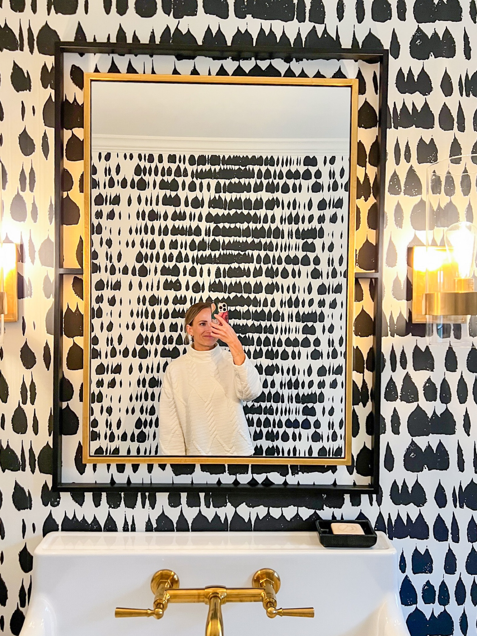 Modern powder bathroom — black and gold mirror, simple gold sconces, and a fun black and white wallpaper. #homedecor 

#LTKhome