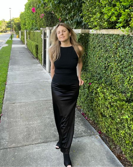Another view... It’s a black lurex halter neck knit top with a black long satin slip skirt + peep toe / open toe boots. Monochromatic black outfit.

Wedding guest outfit, date night outfit, night out outfit, cocktail party outfit, holiday party outfit.

#LTKshoecrush #LTKparties #LTKstyletip