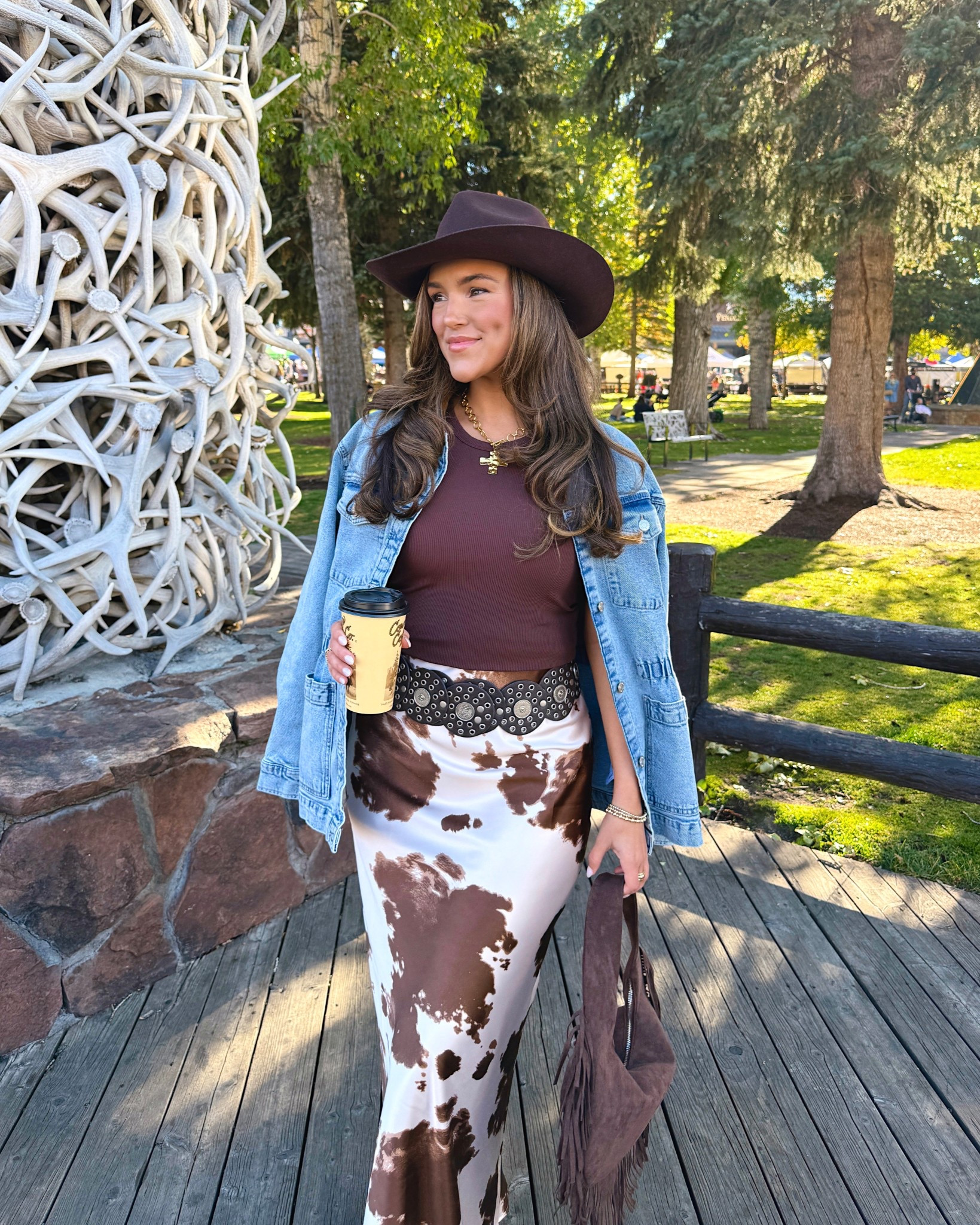 Jackson hole Wyoming outfit inspo & fall outfit idea! Denim jacket and cow print skirt and brown cowboy hat and fringe purse! Plus some Amazon jewelry

#LTKFindsUnder100
