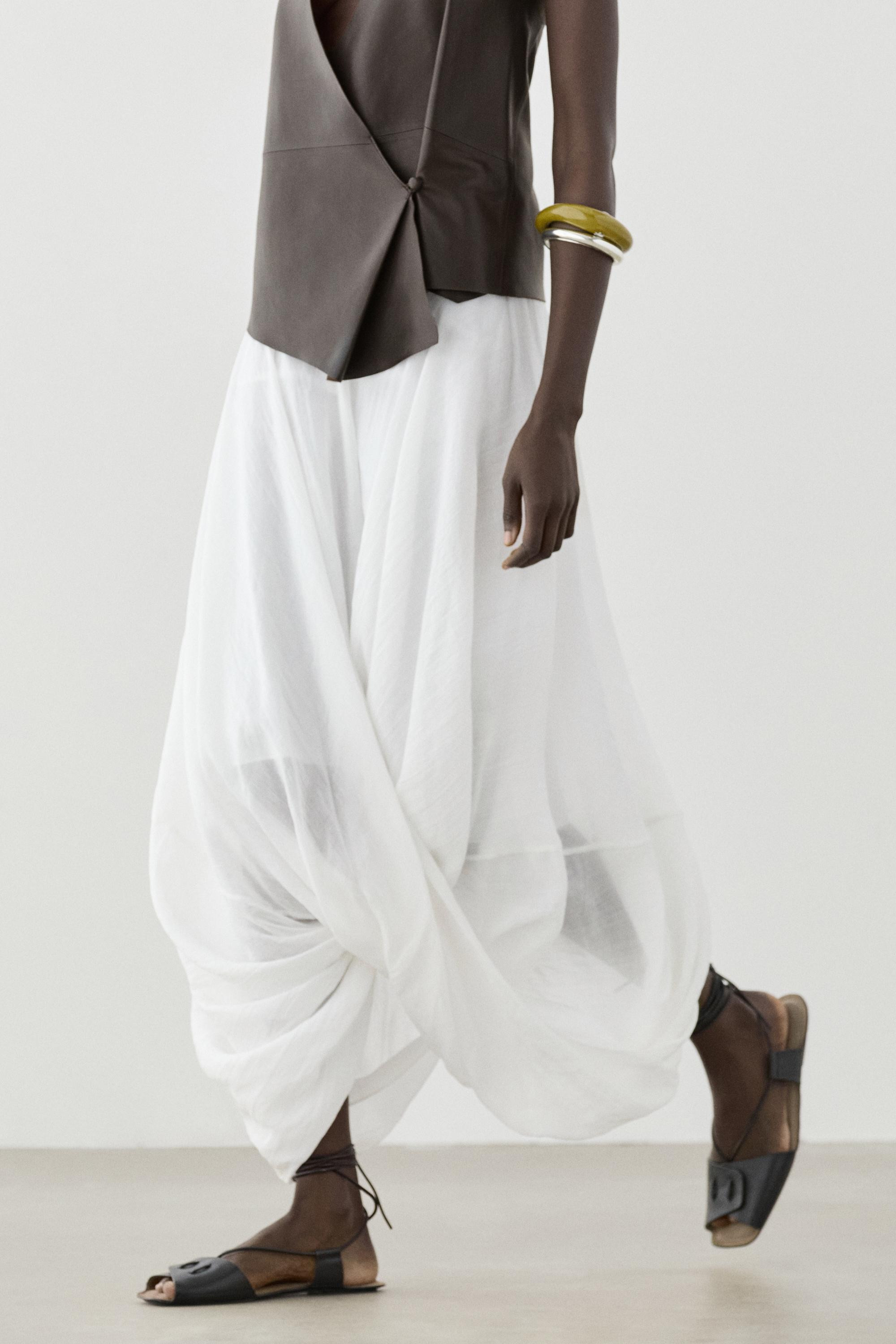 Light volume midi skirt. Zip fastening at the back. Draped crossover hem. Cotton lining. Flowing ... | Massimo Dutti US