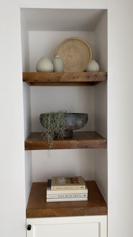 Living room shelves styled with vases, bowls, books and plants.  

Home decor, sconces, home books, vases, wooden bowl, modern bowl, Spanish moss. 

#LTKhome #LTKunder100 #LTKunder50