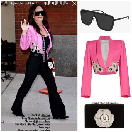 Kyle Richards’ Pink Cropped Butterfly Jacket, Black Shield Sunglasses and Flower Embellished Black Purse