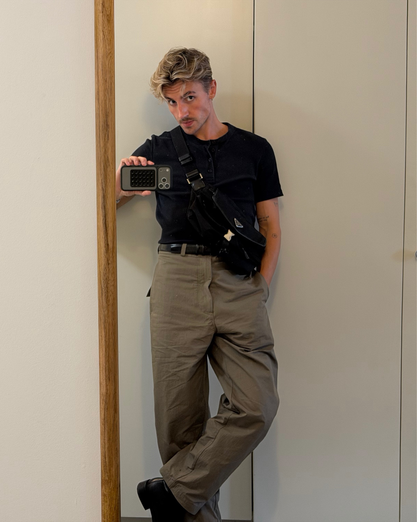 Mes black Henley, beige trousers and black cargo boots with Prada bag

#LTKmens #LTKluxury #LTKautumn