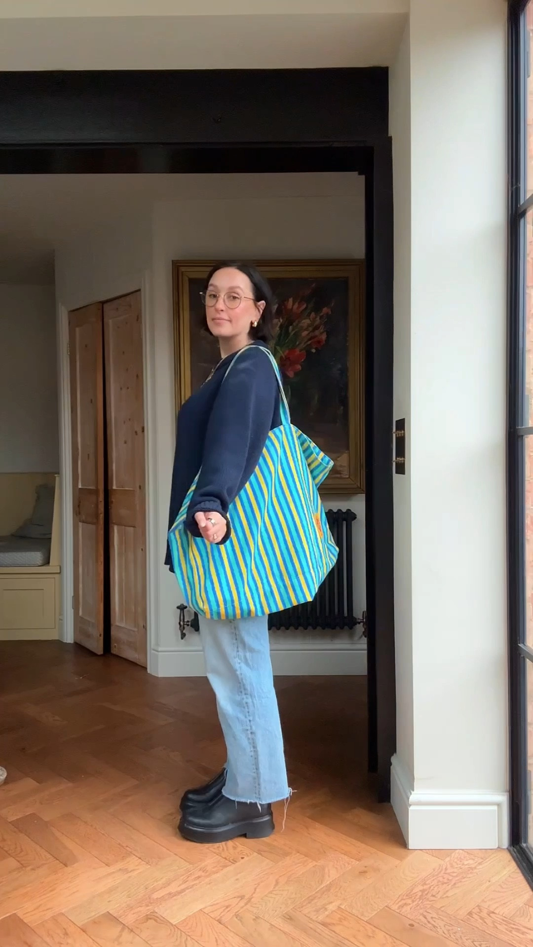 Casual midsize over 40 outfit idea 

Straight leg jeans 
Navy jumper 
White t-shirt 
Black boots 
Striped tote bag 


#LTKspring #LTKuk #LTKmidsize