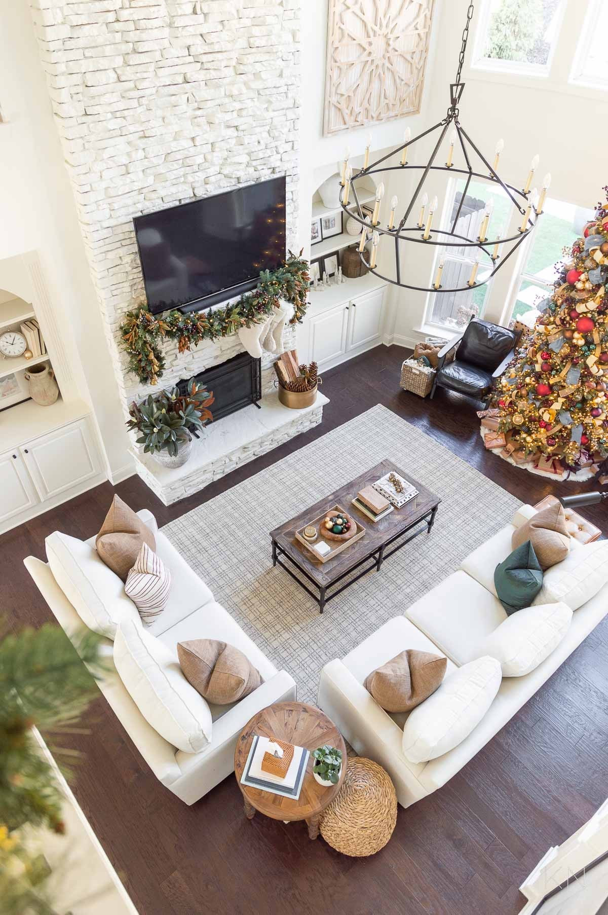 Before I share this year’s Christmas decor, here’s a look back at my red, blue, green and gold color scheme from a past Christmas. home decor Christmas decor great room decor living room decor pottery barn sofas black leather chairs checked area rug iron chandelier #LTKStyleTip

#LTKHome #LTKHoliday