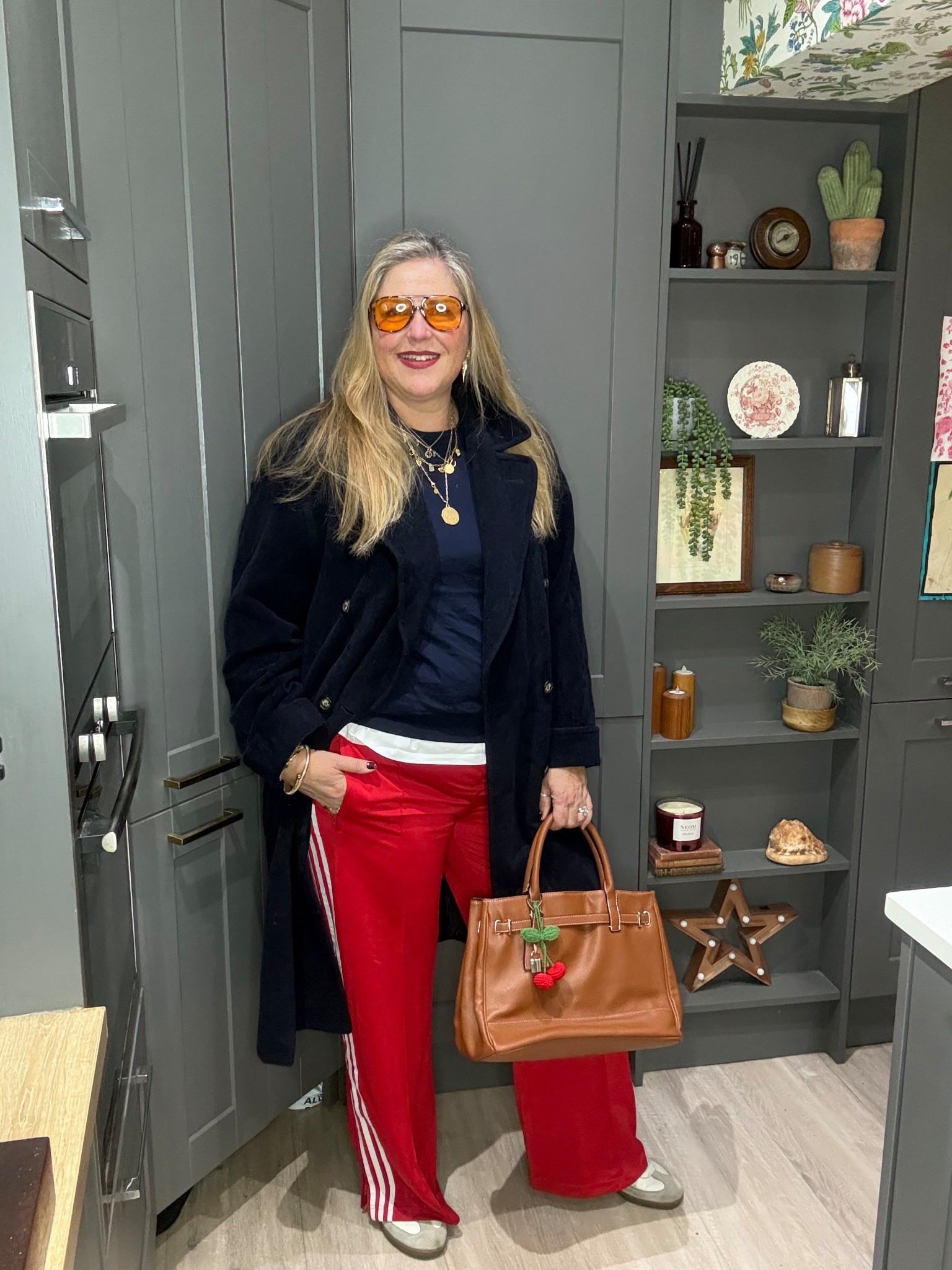 Red side stripe trackpants, navy overcoat, navy jumper, white tshirt, tan tote bag, trainers, sunglasses 

#LTKcurves #LTKspring #LTKplussize