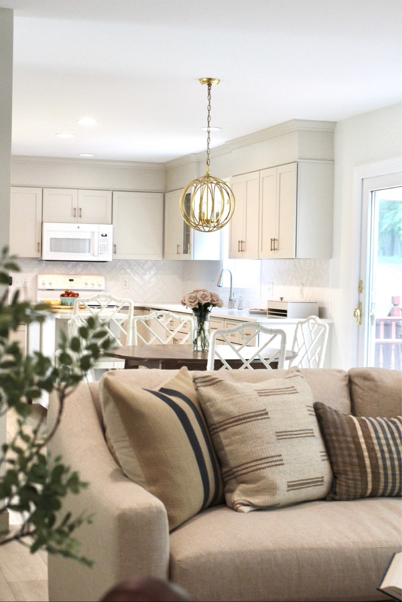 Open concept living room, dining room, kitchen design, neutral cozy homey decor, light and bright decor, cream cabinets, throw pillows, accent pillows, neutral couch, pendant light, remodel, white dining chairs, round kitchen table, round dining room table, eat in kitchen, accent chair, interior designer, interior decor

#shannonrussointeriors #interiordesigner

#LTKhome