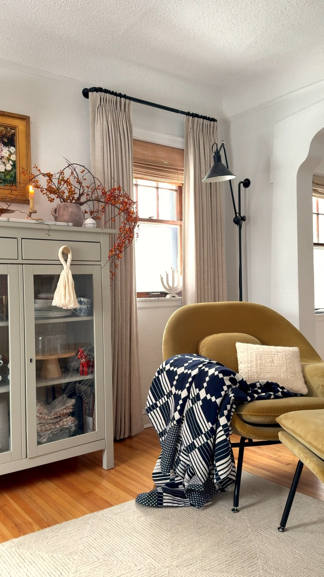 Infusing some warmth into this corner in more ways than one! Draperies, soft accessories and organic elements like bittersweet vines bring visual warmth and personality. AND lined drapes help keep out cold drafts at night. 🥶

 I have a love/hate with these old windows! The charm is unmatched, but of course, they aren’t the most energy efficient.  Lobbing out 50k+ on new windows makes my head do this though: 🤯. So insulated drapes it is for now! 😂

#LTKHome #LTKSeasonal