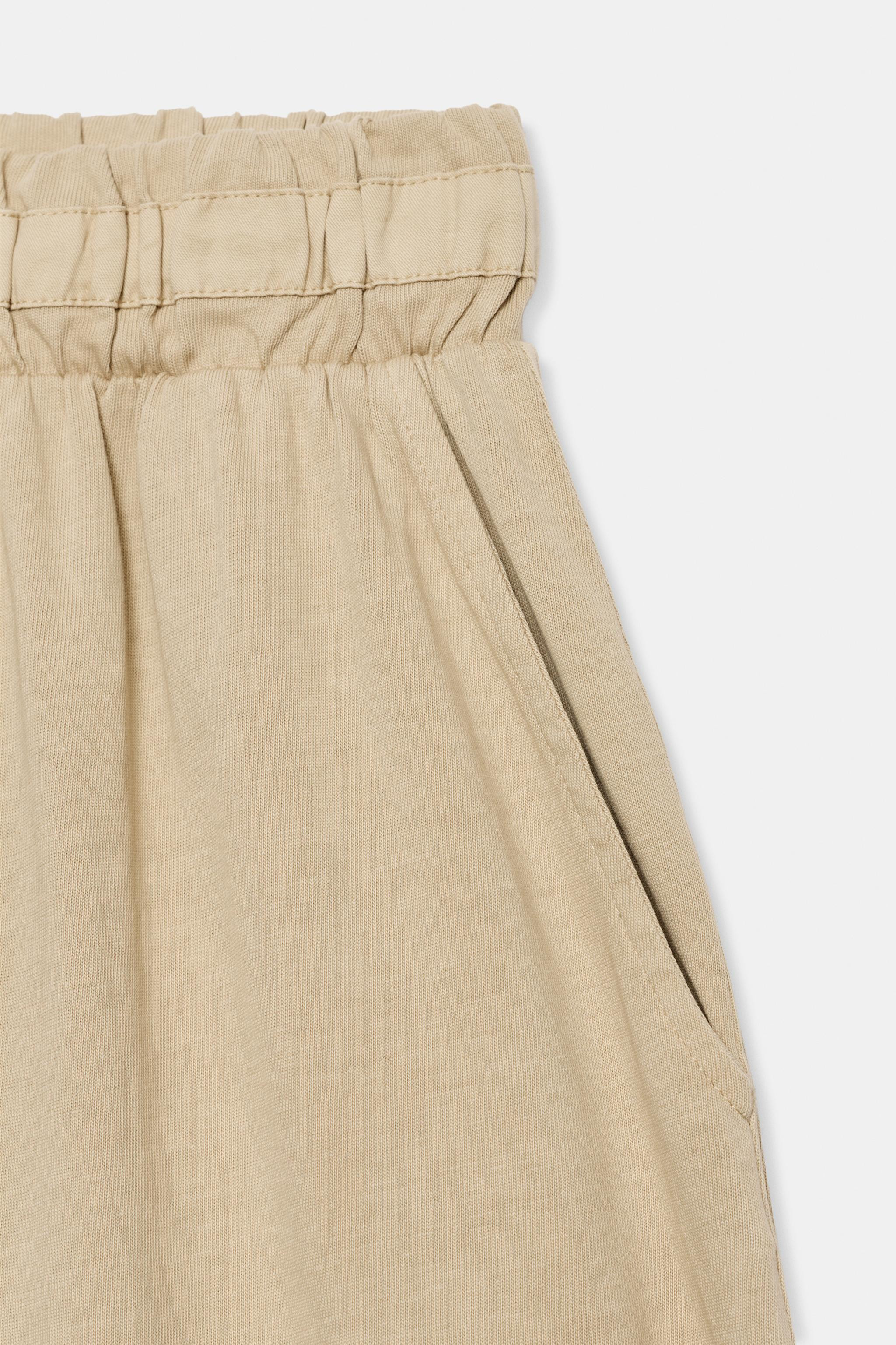 High-rise trousers crafted from 100% cotton yarn. Featuring a mid-rise waist with adjustable matc... | Zara US